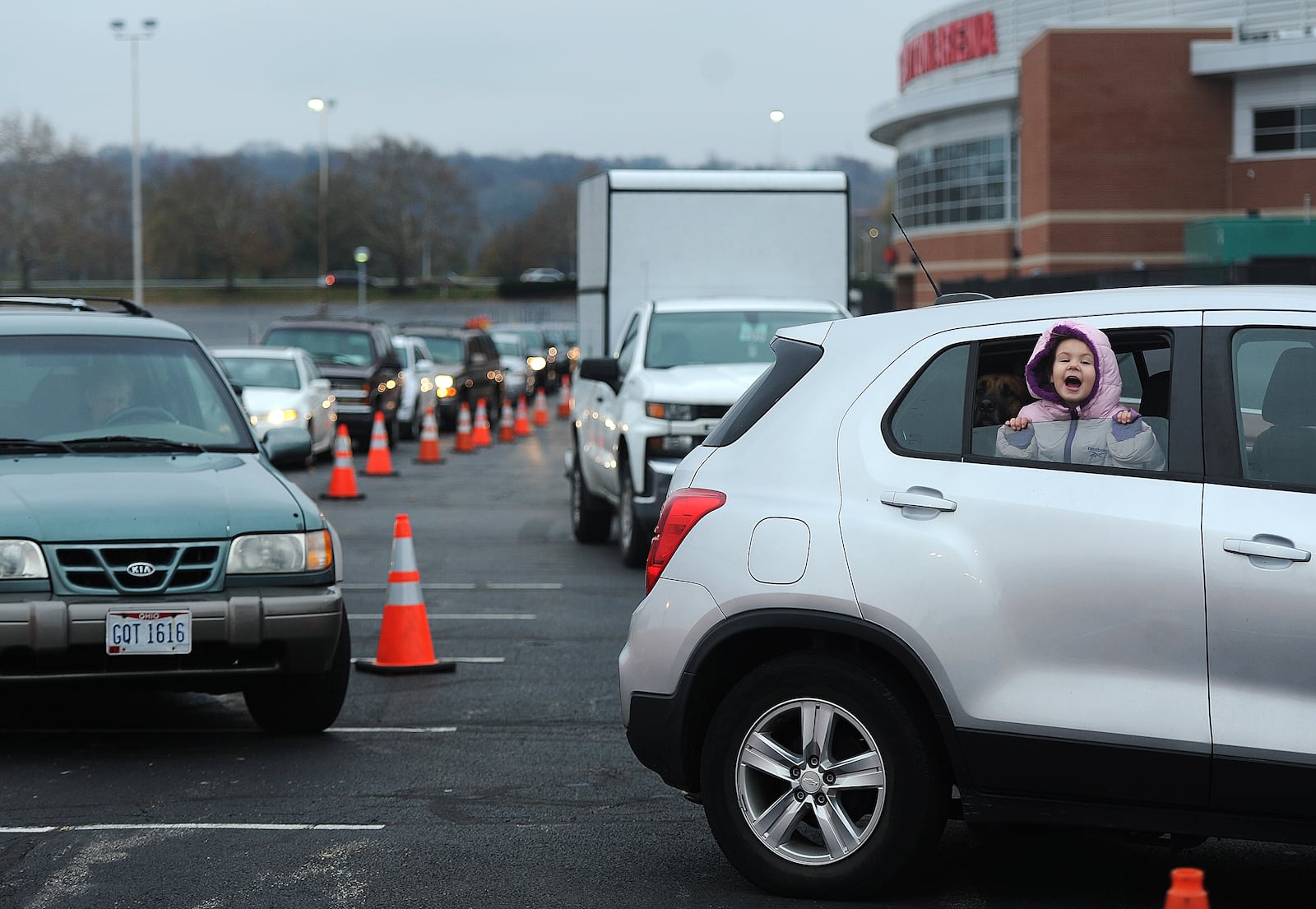 Delilah Rose, age 4, waits in line with her great grandmother at the Miami Valley Meals Turkey Takeaway event at the University of Dayton Arena, Wednesday, Nov. 22, 2023 for those experiencing food insecurity. MARSHALL GORBY\STAFF