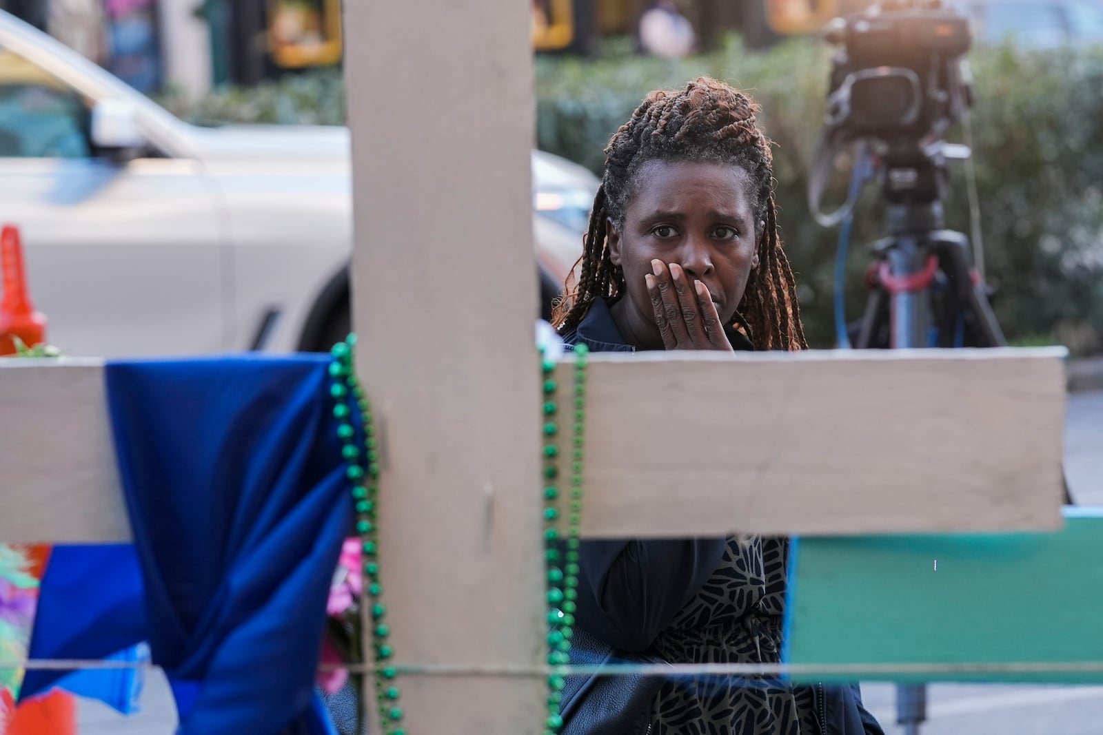 Katriel Faith Gibson, who lives nearby, reacts as she visits a memorial on Canal Street for the victims of a deadly truck attack on New Year's Day in New Orleans, Friday, Jan. 3, 2025. (AP Photo/Gerald Herbert)