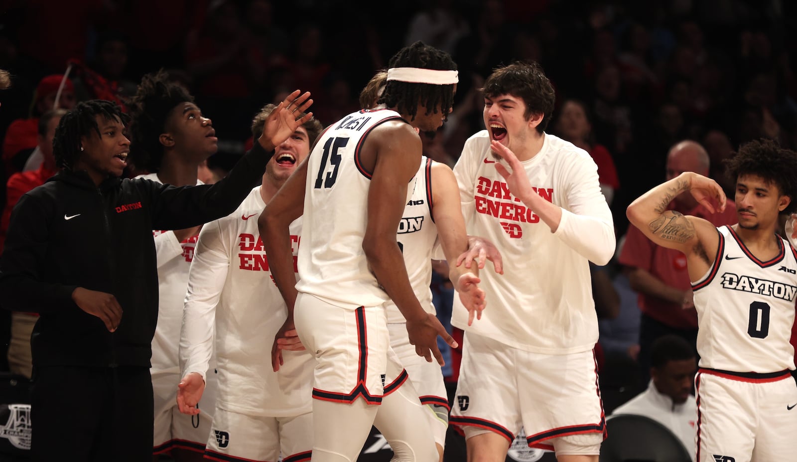 Dayton's DaRon Holmes II celebrates with teammates after a basket and a foul against Duquesne in the Atlantic 10 Conference tournament quarterfinals on Thursday, March 14, 2024, at the Barclays Center in Brooklyn, N.Y. David Jablonski/Staff