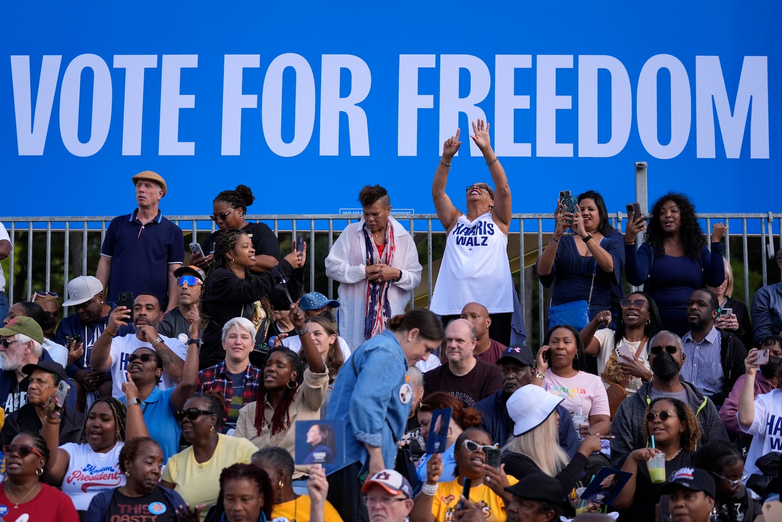 Attendees wait for Democratic presidential nominee Vice President Kamala Harris to arrive at a campaign rally outside the Atlanta Civic Center, Saturday, Nov. 2, 2024. (AP Photo/Brynn Anderson)