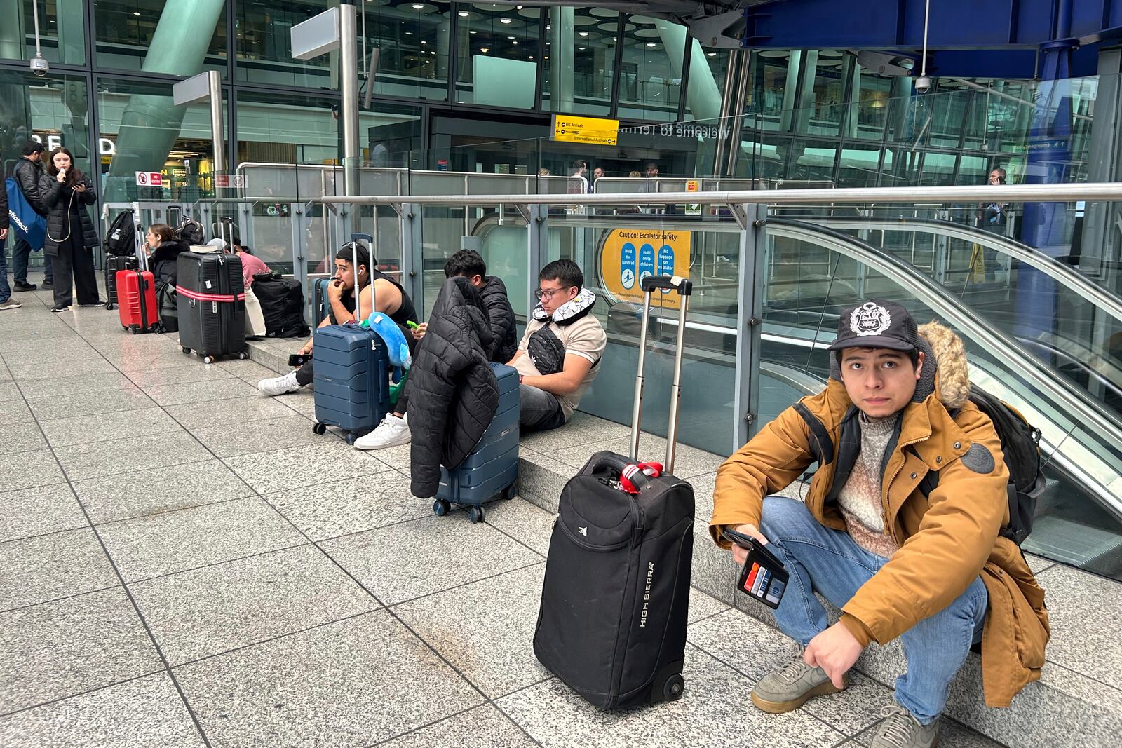 Travellers are waiting as Britain's Heathrow Airport has closed for the full day Friday after an electrical substation fire knocked out its power, disrupting flights for hundreds of thousands of passengers at one of Europe's biggest travel hubs in London, Friday, March 21, 2025.(AP Photo/Kin Cheung)