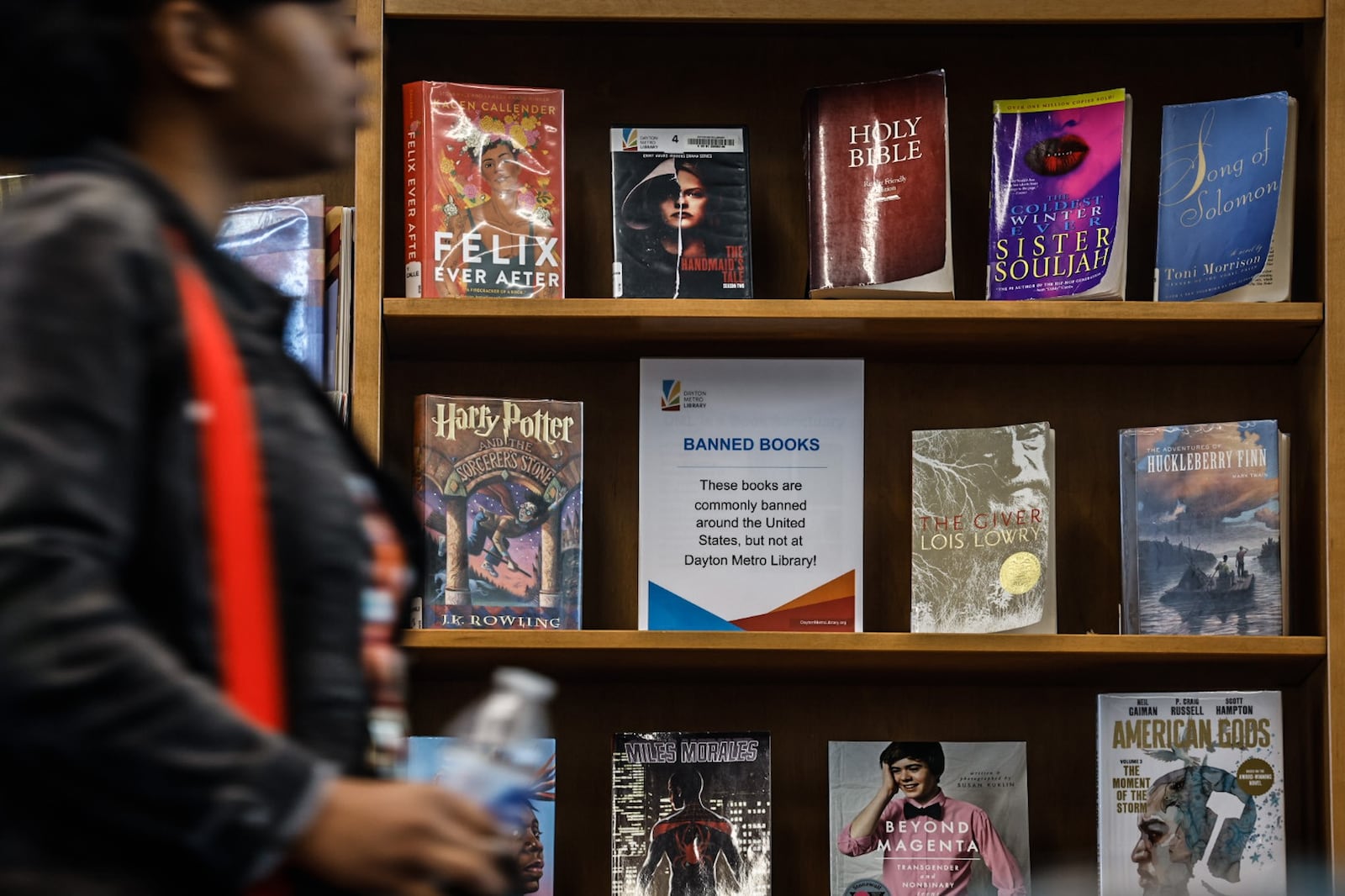 The Trotwood branch of the Dayton Metro Library has a bookshelf displaying the most popular banned books across the country. Trotwood teen librarian Steve Moser said that the most targeted books in 2022 were subjects about LGBTQ+ and Black people. JIM NOELKER/STAFF