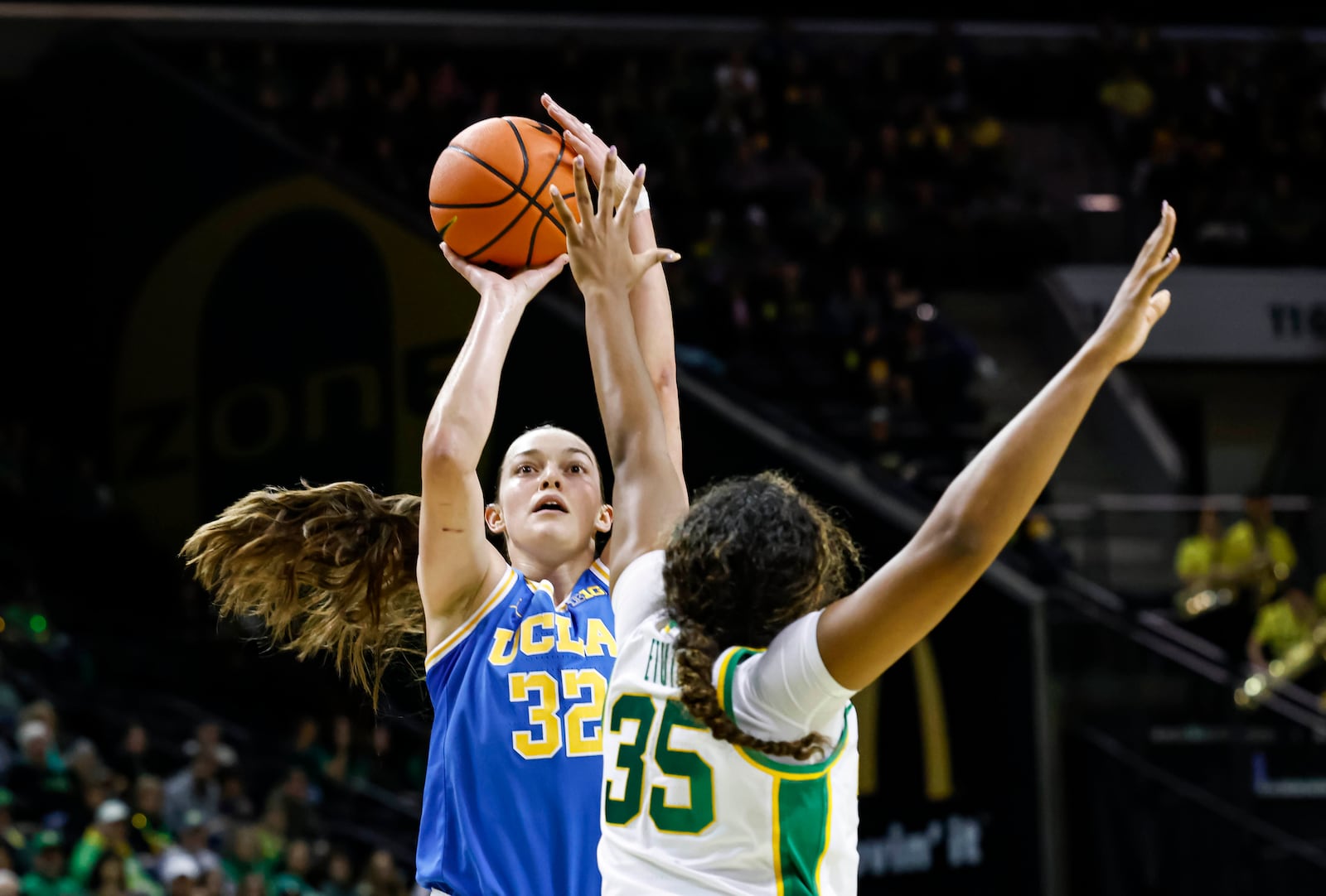 UCLA forward Angela Dugalic (32) shoots against Oregon forward Ehis Etute (35) in the second half of an NCAA college basketball game in Eugene, Ore., Sunday, Feb. 9, 2025. UCLA beat Oregon 62-52. (AP Photo/Thomas Boyd)