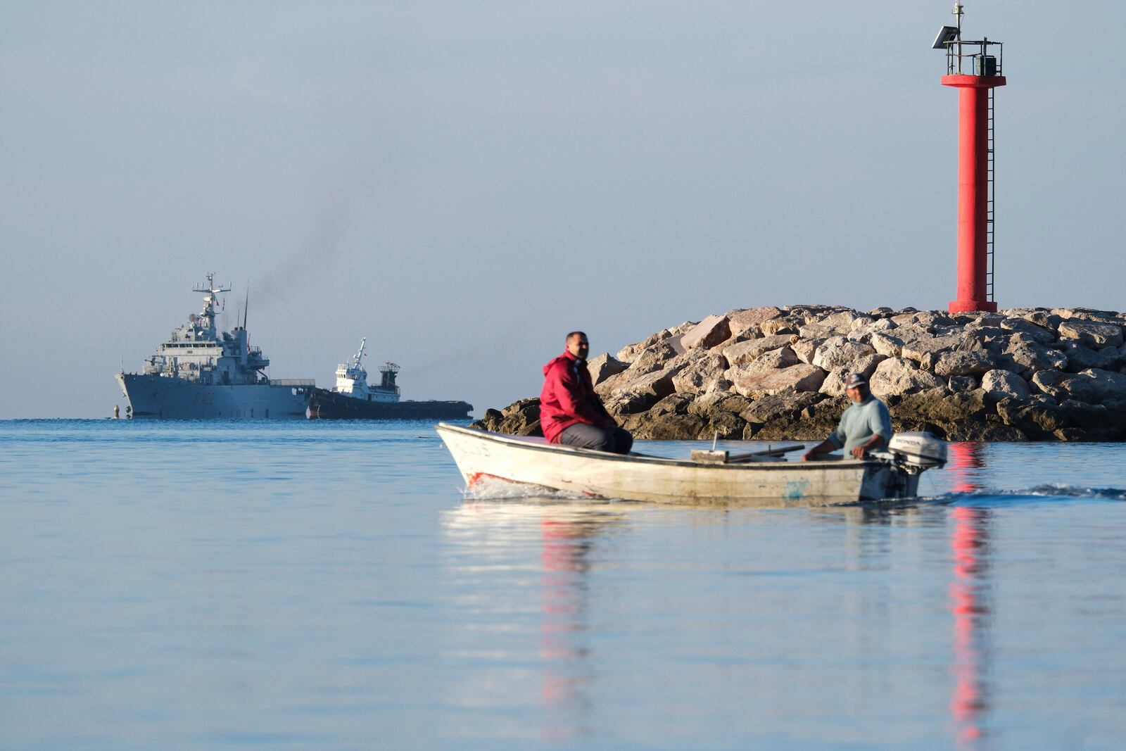 The Italian navy ship Libra, left, approaches the port of Shengjin, northwestern Albania, Friday, Nov. 8, 2024, with the second group of eight migrants intercepted in international waters to be processed there in a reception facility despite the failure with the first group last month.(AP Photo/Vlasov Sulaj)