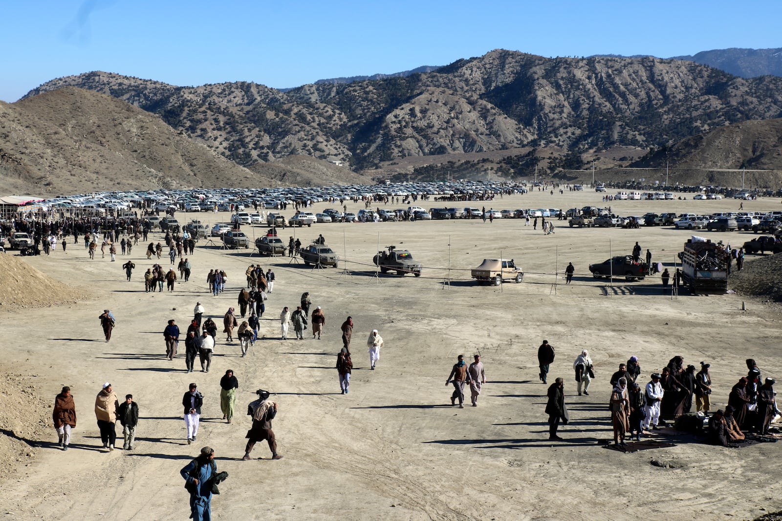 People attend the funeral prayer of Khalil Haqqani, the minister for refugees and repatriation, during his funeral procession in eastern Paktia province, Afghanistan, Thursday, Dec. 12, 2024.(AP Photo/Saifullah Zahir)