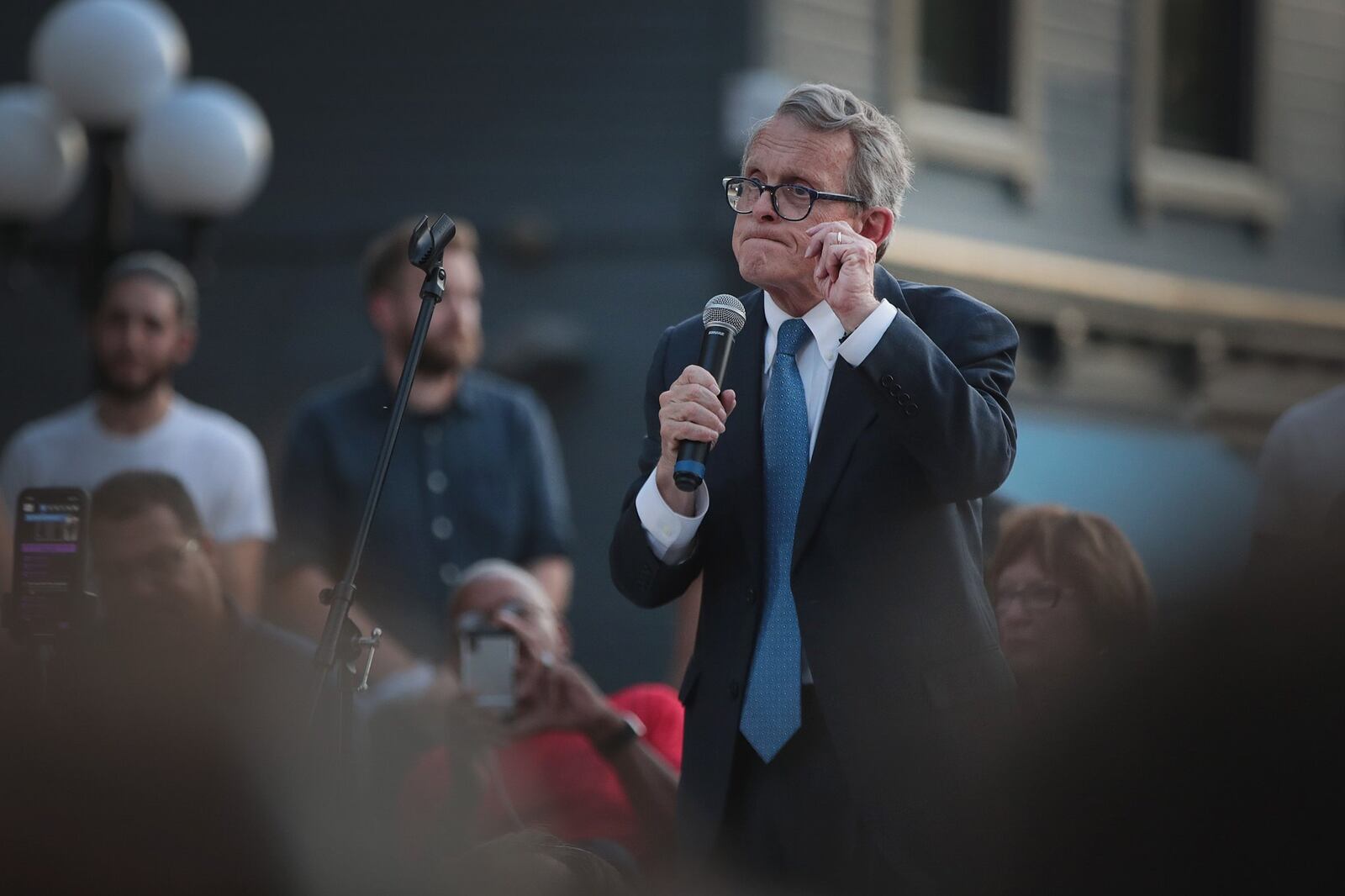 Ohio Governor Mike DeWine speaks to mourners at a memorial service in the Oregon District held to recognize the victims of an early-morning mass shooting in the popular nightspot on August 04, 2019 in Dayton, Ohio. The governor was met with shouts of “Do something” from the crowd. At least 9 people were reported to have been killed and another 27 injured when a gunman identified as 24-year-old Connor Betts opened fire with a AR-15 style rifle. The shooting comes less than 24 hours after a gunman in Texas opened fire at a shopping mall killing at least 20 people. (Photo by Scott Olson/Getty Images)