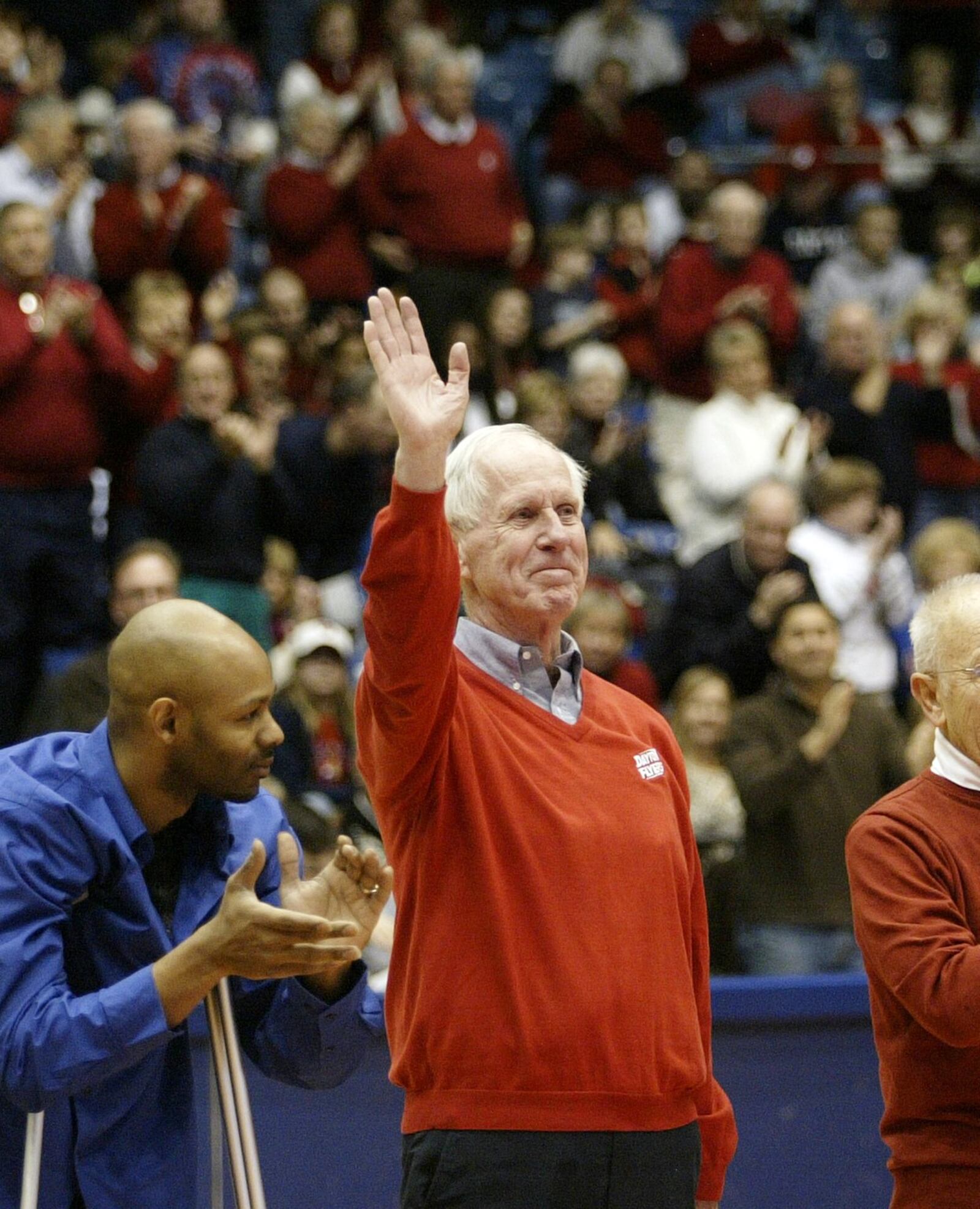 University of Dayton Hall of Famer and legendary basketball coach Don Donoher receives a standing ovation from the crowd at UD Arena. FILE PHOTO