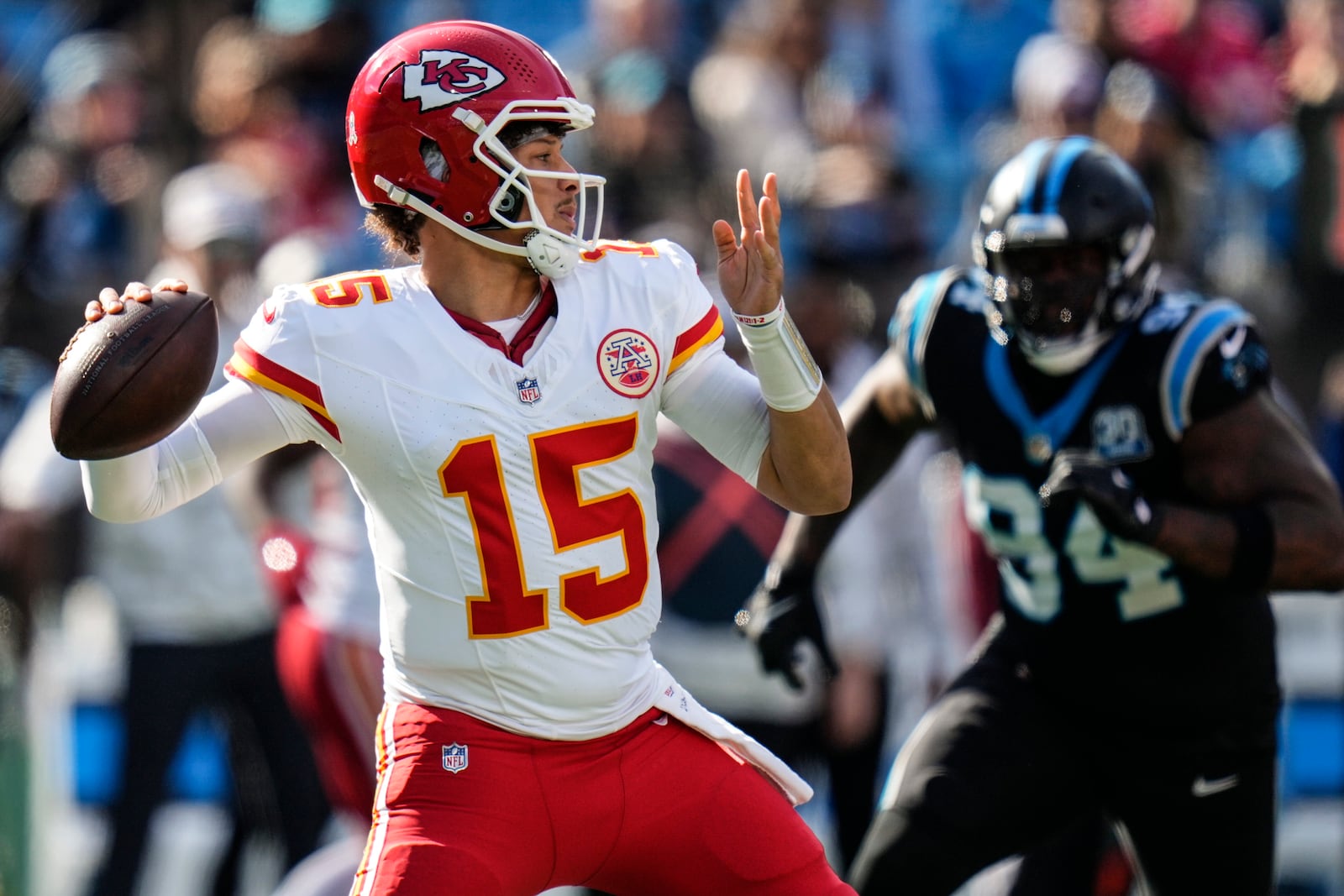 Kansas City Chiefs quarterback Patrick Mahomes (15) works in the pocket against the Carolina Panthers during the first half of an NFL football game, Sunday, Nov. 24, 2024, in Charlotte, N.C. (AP Photo/Rusty Jones)