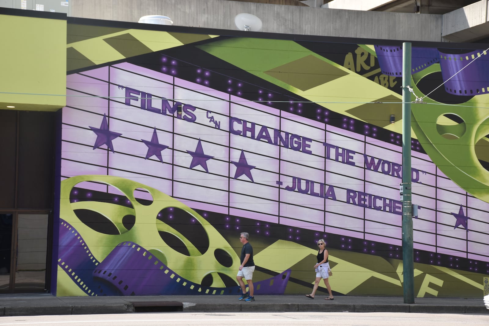 The Neon, an art house cinema in downtown Dayton, has a colorful new exterior. The mural pays tribute to Julia Reichert, a local, Oscar-winning documentarian. CORNELIUS FROLIK / STAFF