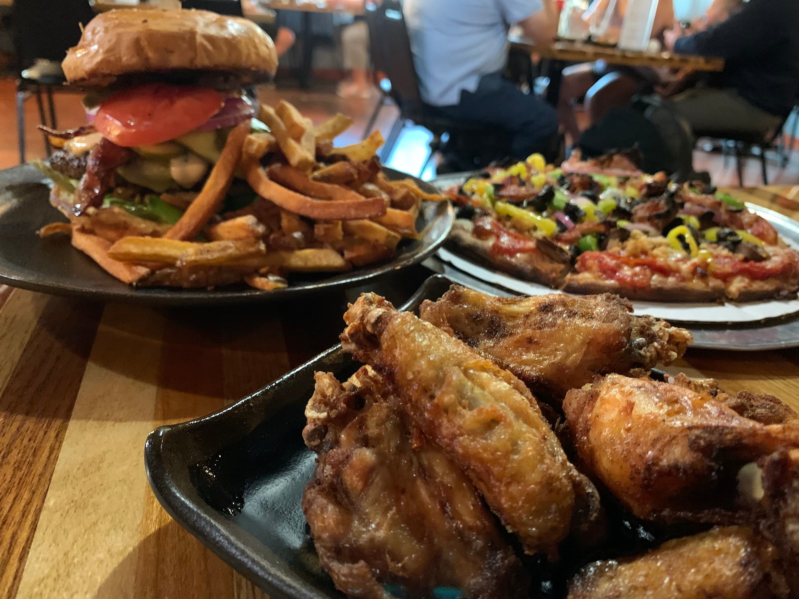 Chicken wings, a burger and fries and pizza at 571 Grill and Draft House