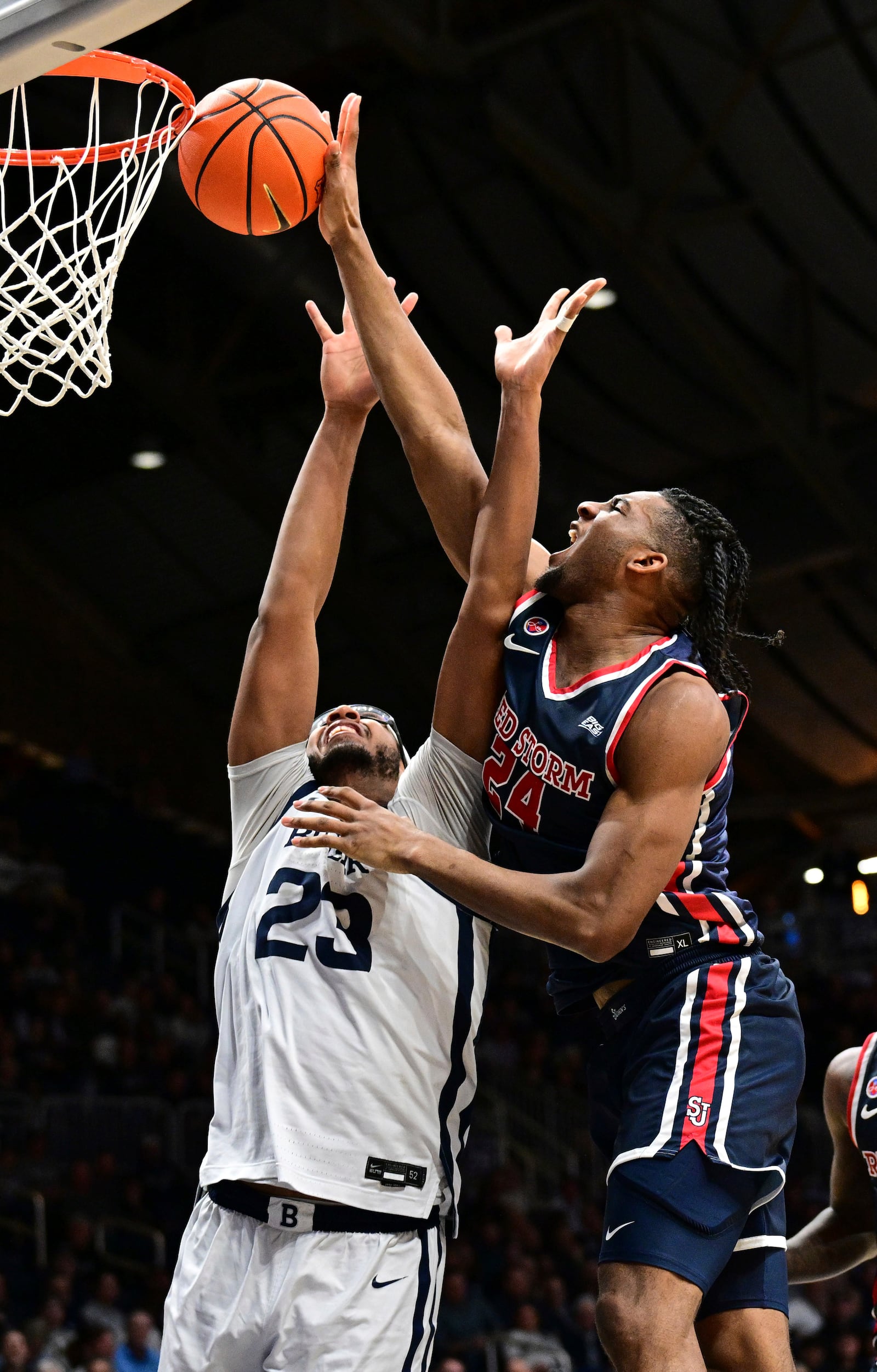 St. John's forward Zuby Ejiofor (24) reaches for a ball that is against the rim in front of Butler center Andre Screen (23) during the second half of an NCAA college basketball game, Wednesday, Feb. 26, 2025, in Indianapolis, Ind. (AP Photo/Marc Lebryk)