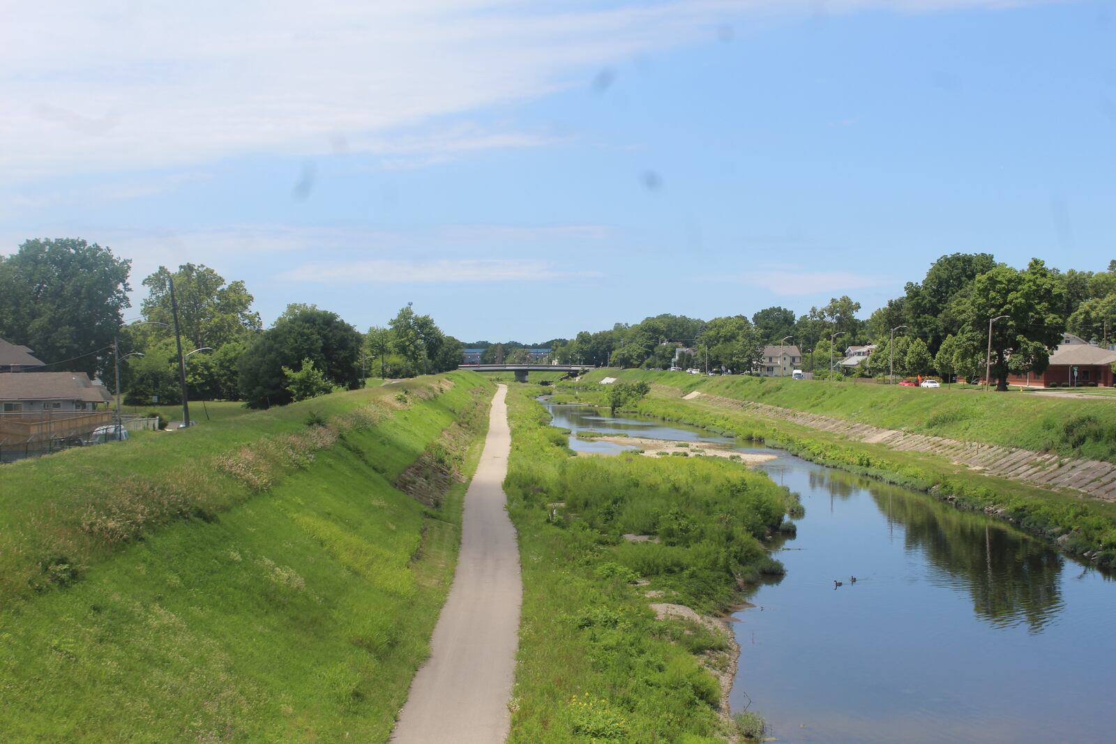 A view of the banks of the Wolf Creek, the levee and the multi-use recreational trail. Dayton wants to see new housing built on the southern side of the waterway in the Wolf Creek neighborhood. CORNELIUS FROLIK / STAFF