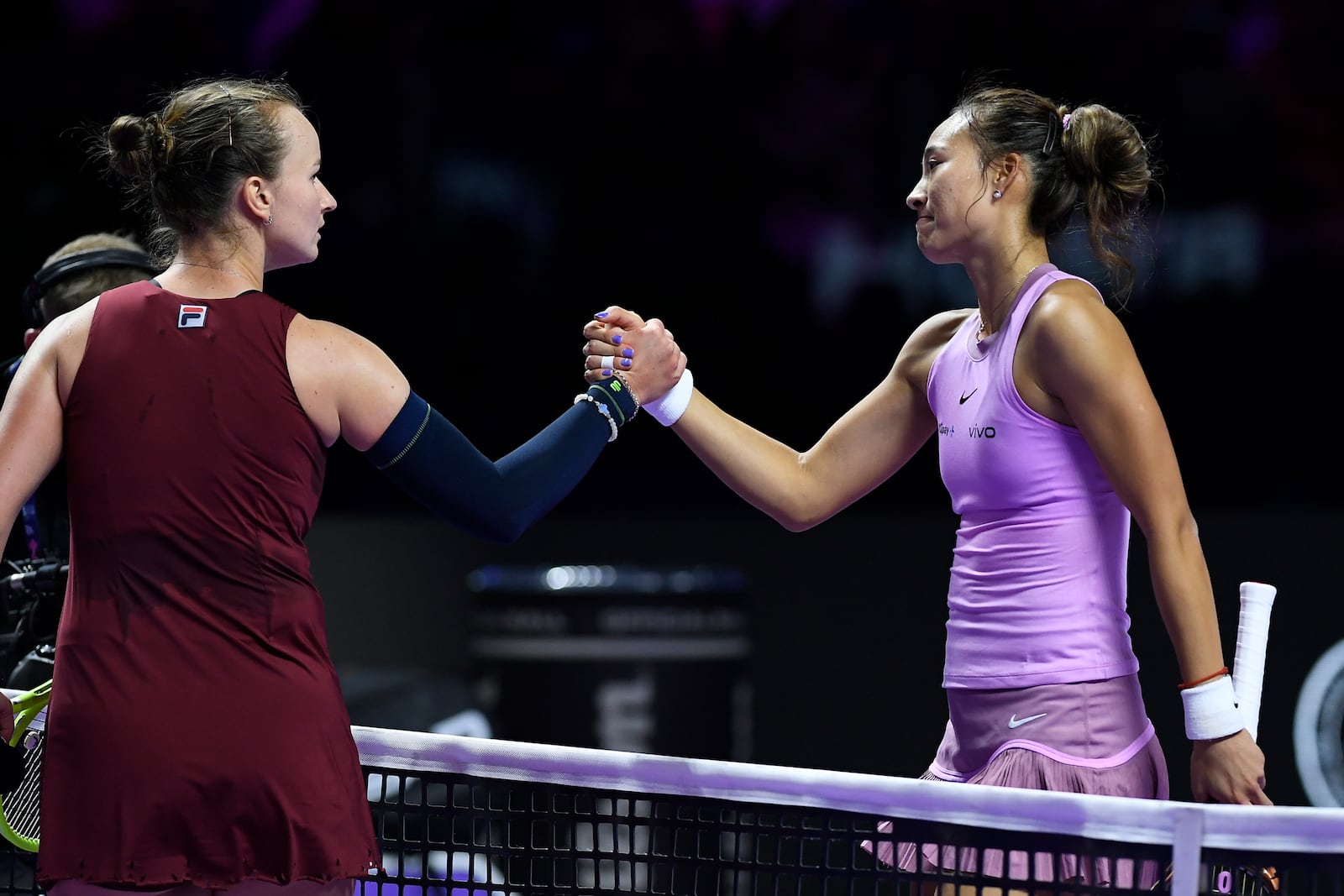 Czech Republic's Barbora Krejcikova, left, shakes hands with winner China's Qinwen Zheng after their women's singles semifinal match at King Saud University Indoor Arena, in Riyadh, Saudi Arabia, Friday, Nov. 8, 2024. (AP Photo)