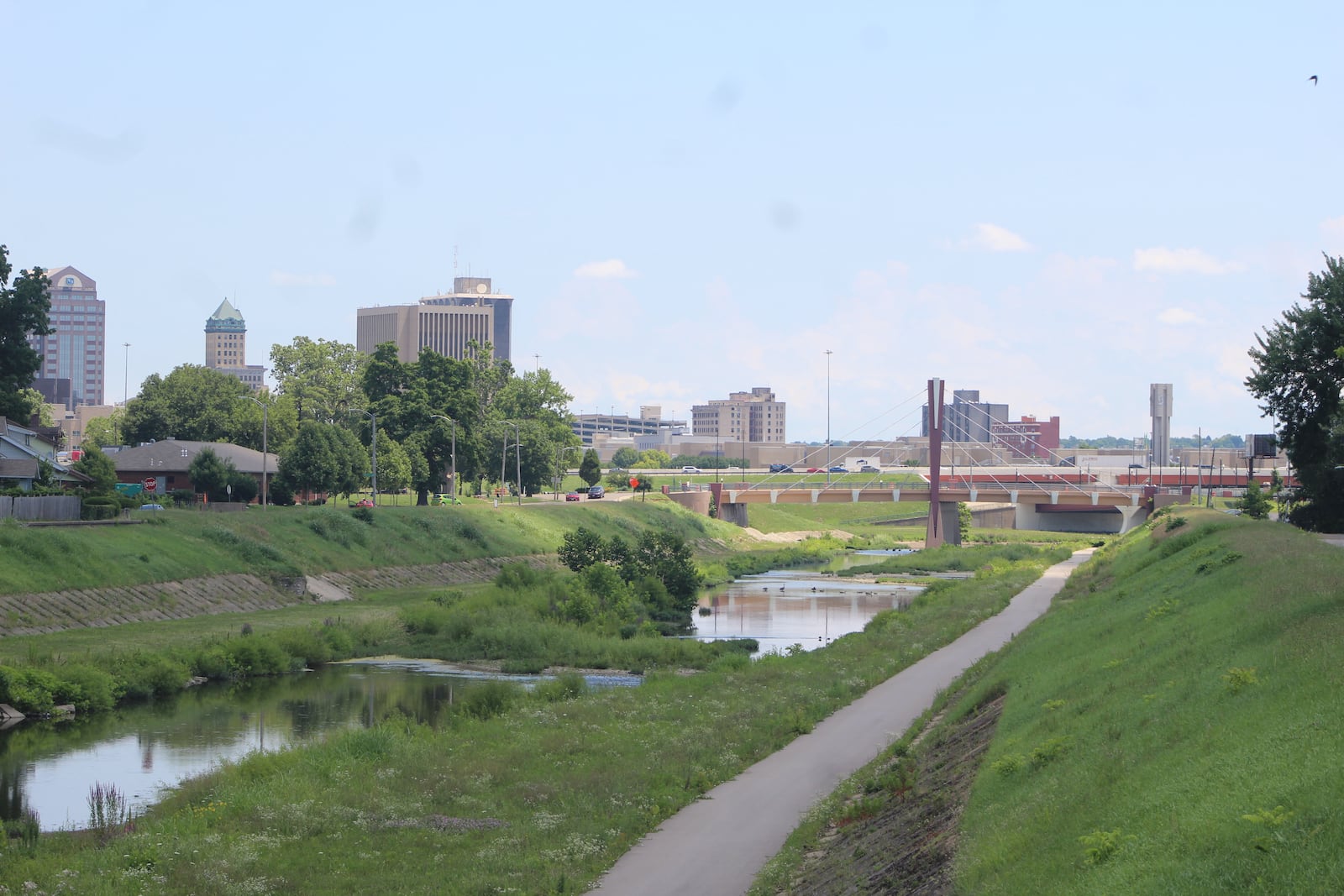 The banks of Wolf Creek, looking east toward downtown Dayton. The city of Dayton is looking for proposals for new housing on the southern side of the river, near the multi-use recreational trail. CORNELIUS FROLIK / STAFF