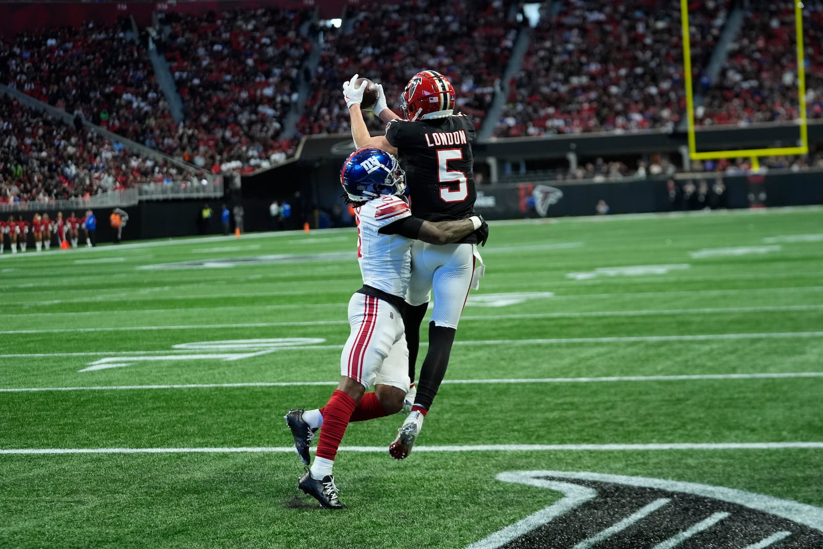 New York Giants cornerback Deonte Banks (3) breaks up a pass intended for Atlanta Falcons wide receiver Drake London (5) in the second half of an NFL football game in Atlanta, Sunday, Dec. 22, 2024. (AP Photo/John Bazemore)