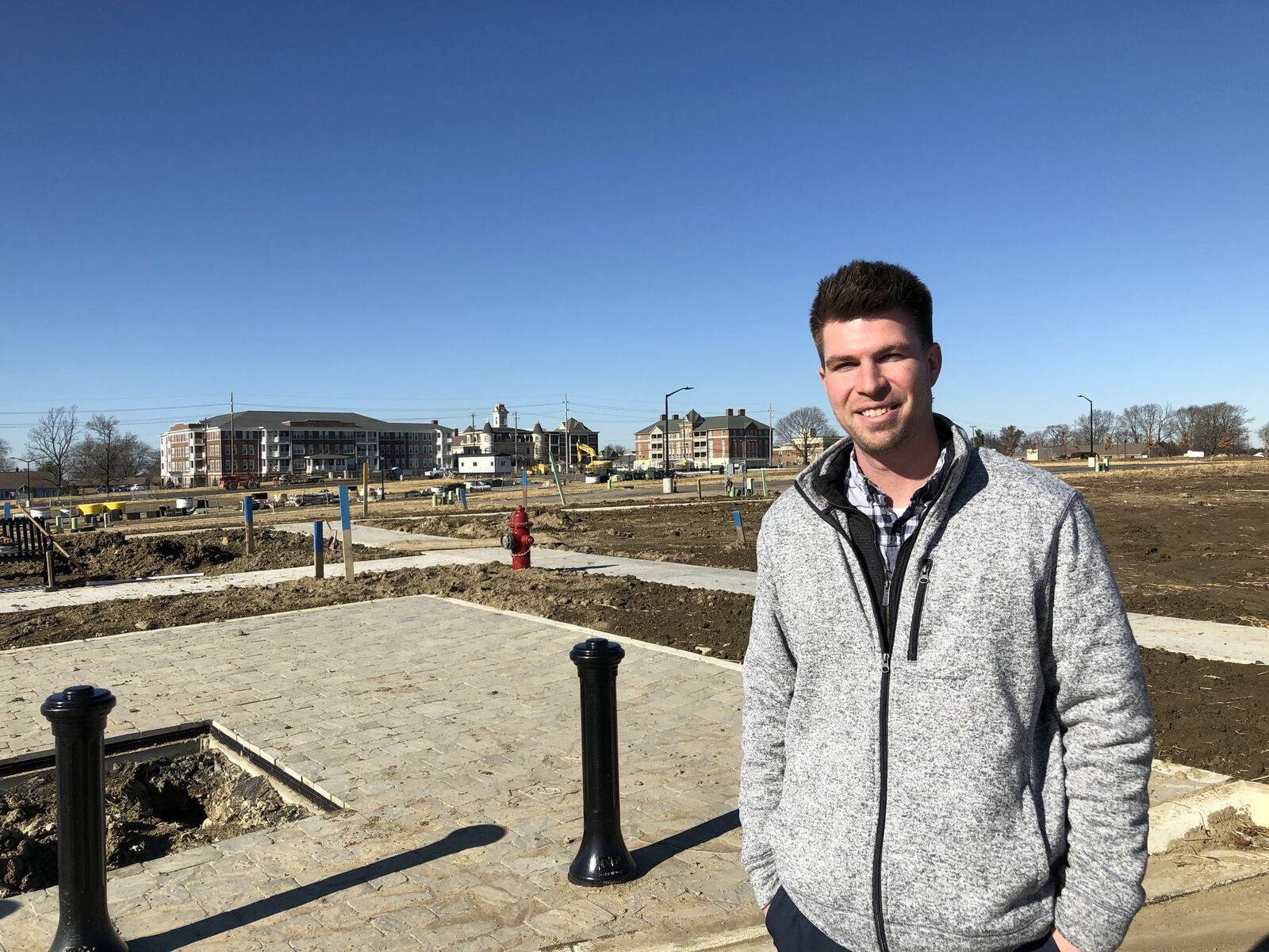 Matt Obringer, project manager for the Union Village planned community in Warren County, stands where the first neighborhood is expected to take shape over the next year. The Otterbein retirement campus stands on the other side of Ohio 741. STAFF/LAWRENCE BUDD