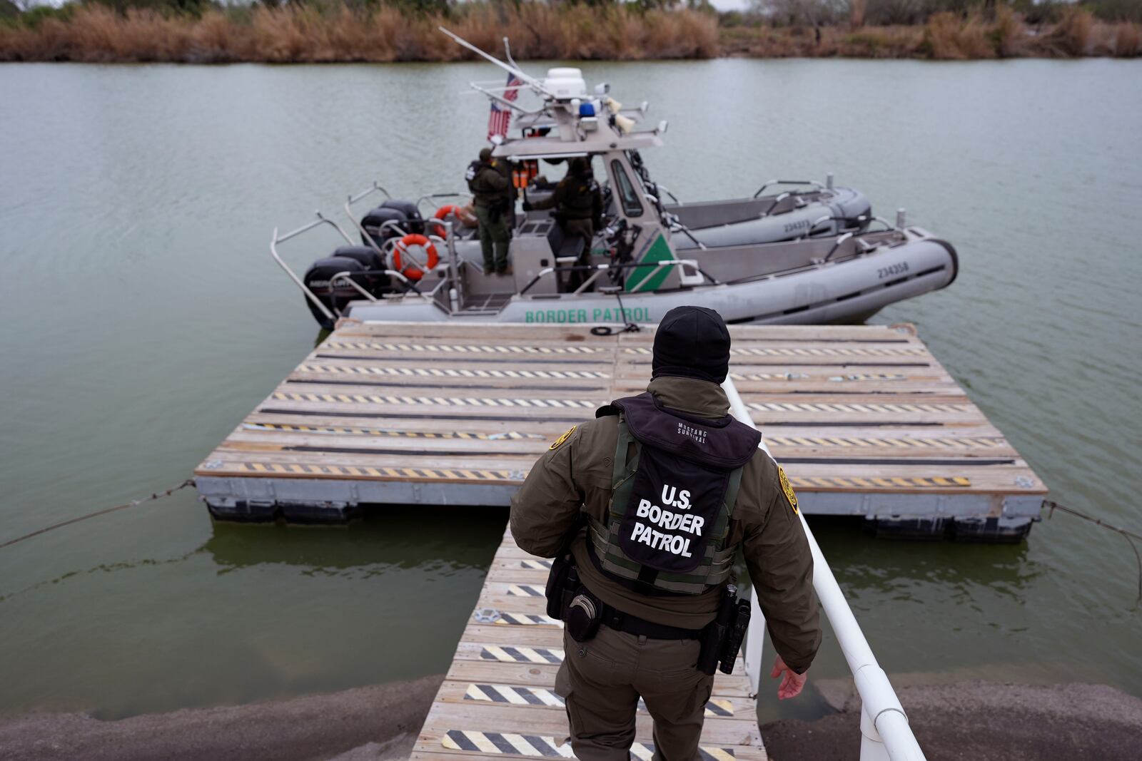 Border patrol agents prepare to board boats to patrol along the Rio Grande at the U.S.-Texas border, Thursday, Feb. 13, 2025, in McAllen, Texas. (AP Photo/Eric Gay)