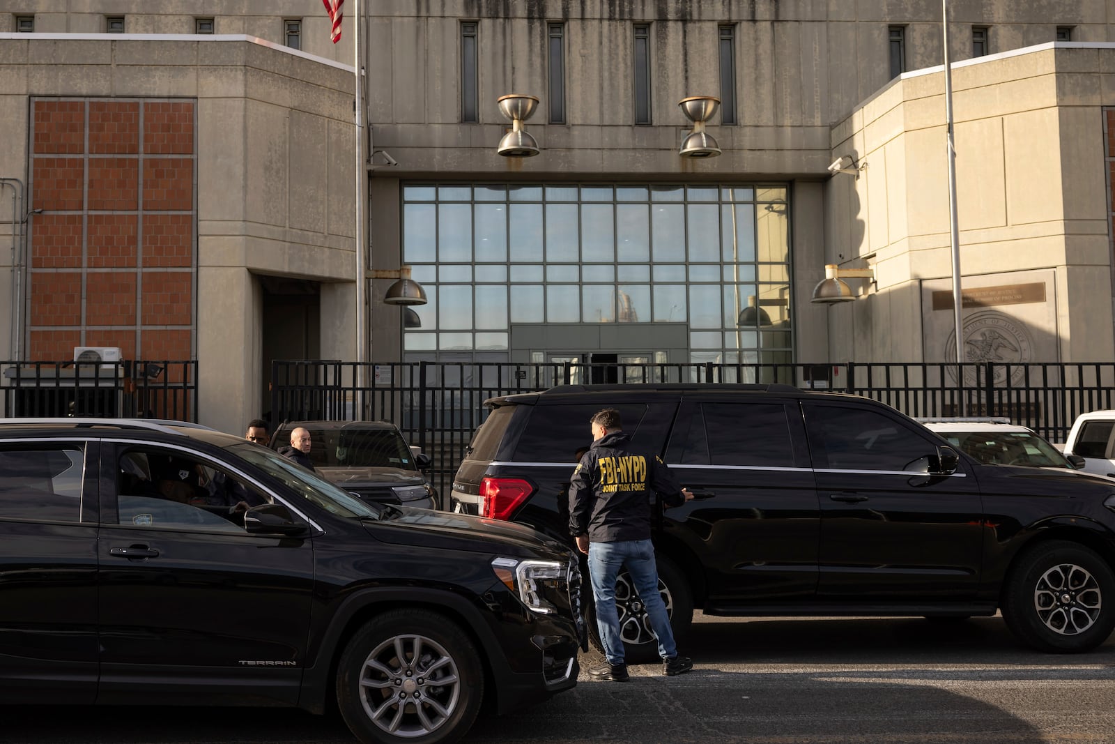 Federal enforcement officers stand outside the Metropolitan Detention Center during an interagency operation, Monday, Oct. 28, 2024, in the Brooklyn Borough of New York. (AP Photo/Yuki Iwamura)