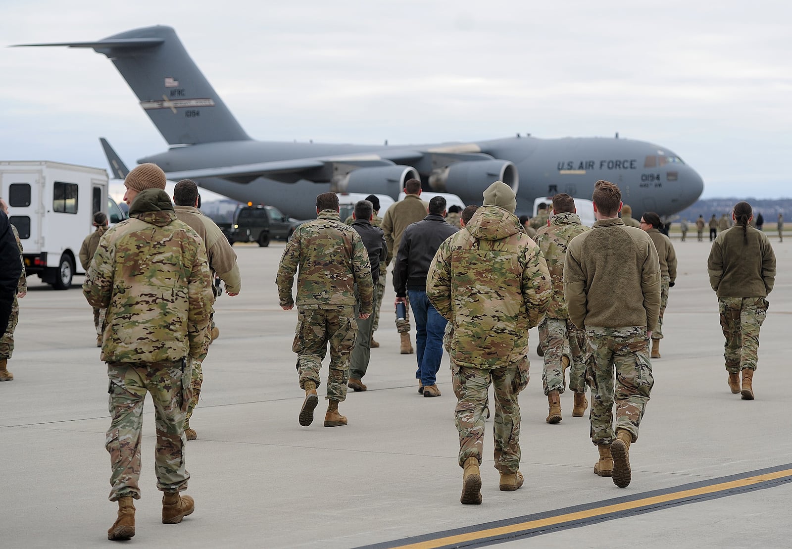 Airmen walk out Thursday, Jan. 4, 2024 to greet a C-17 Globemaster cargo plane, the Airmen returned to Wright-Patterson Air Force Base from more than two months deployed at an undisclosed location. MARSHALL GORBY\STAFF