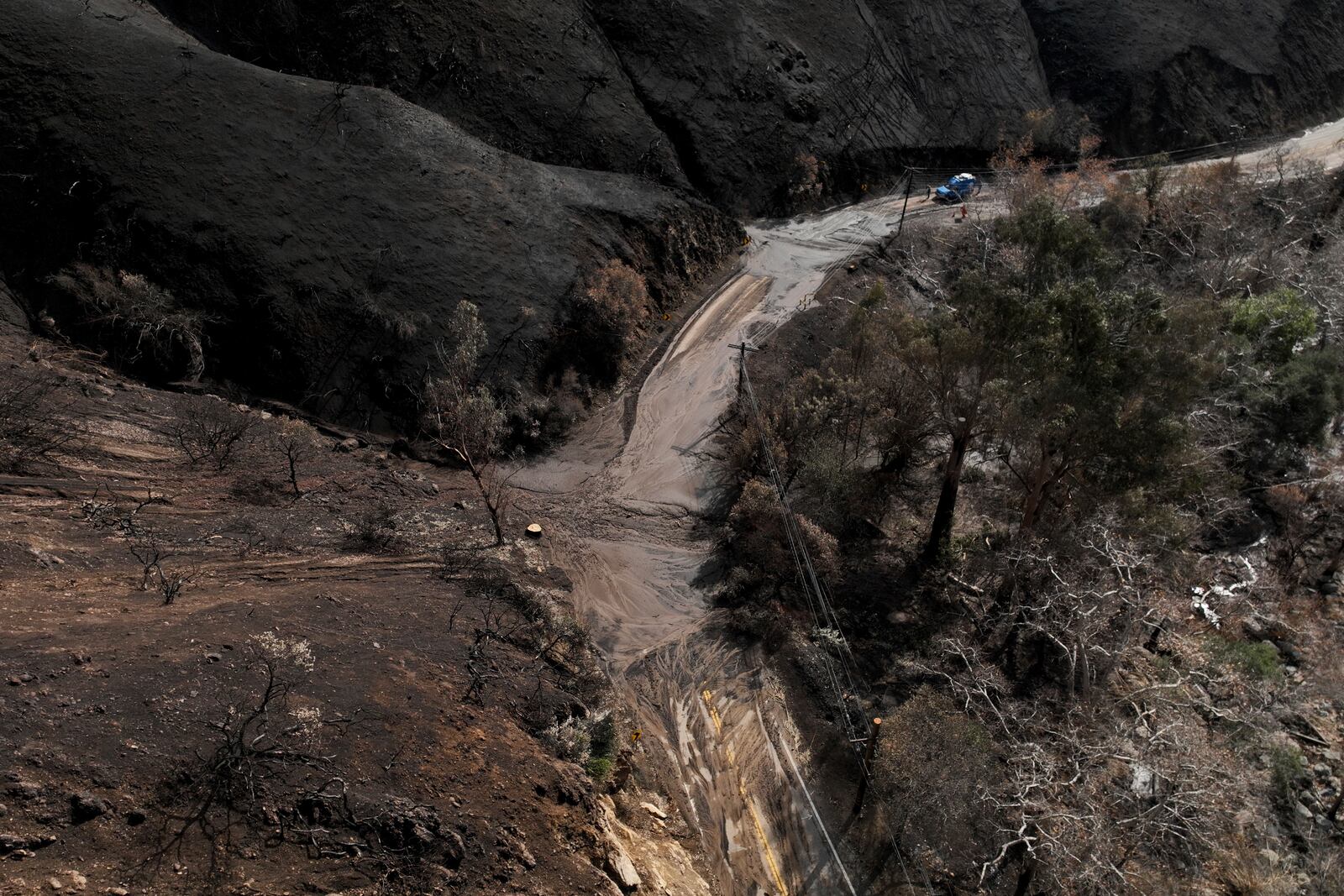 Mud covers Topanga Canyon Rd. on the Palisades Fire burn area after a series of weekend storms Monday, Jan. 27, 2025 near Malibu, Calif. (AP Photo/Jae C. Hong)