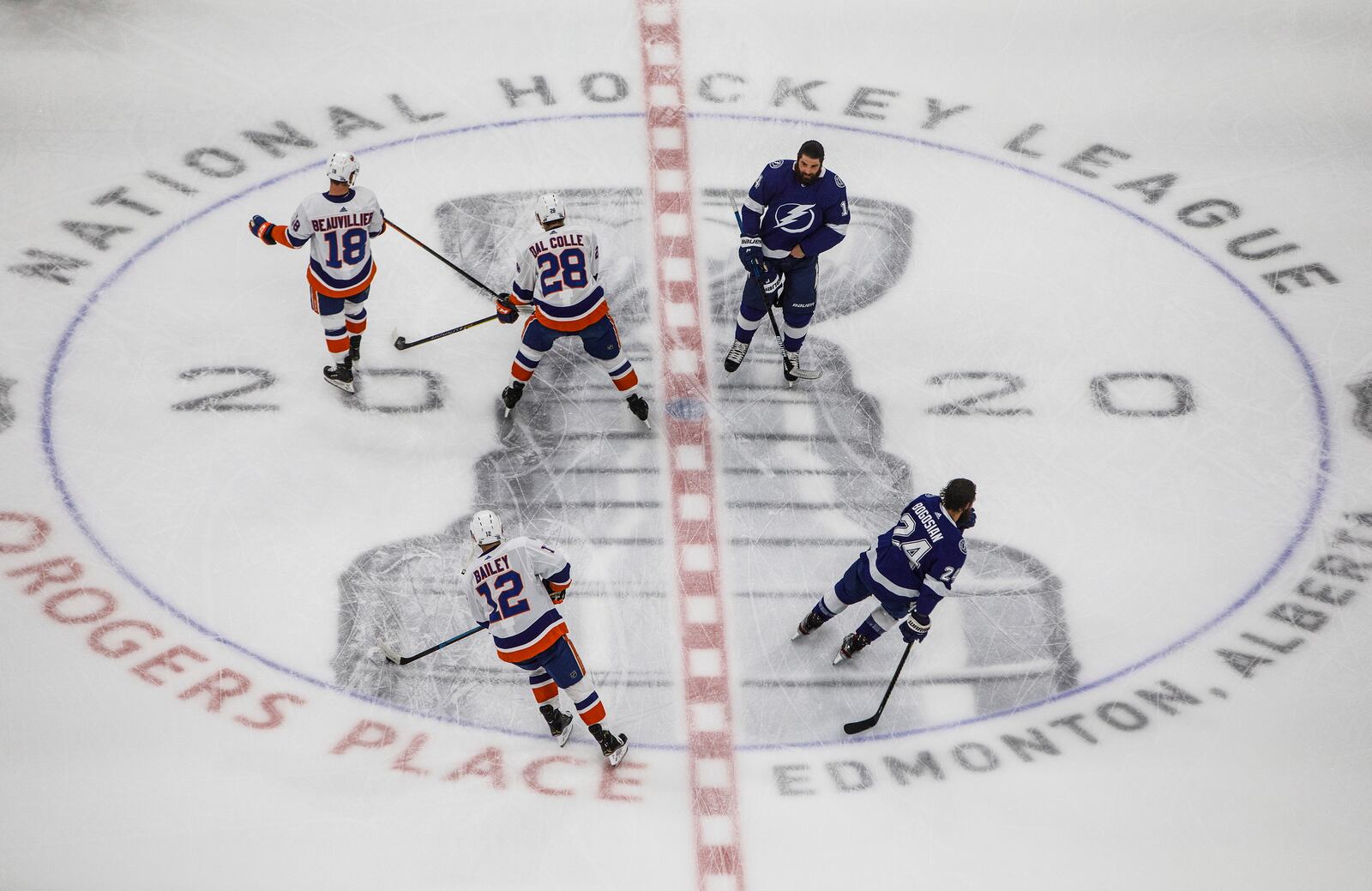 Tampa Bay Lightning's Pat Maroon (14) and teammate Zach Bogosian (24) skate during warm up alongside New York Islanders' Anthony Beauvillier (18) and teammates Michael Dal Colle (28) and Josh Bailey (12) before the first period of an NHL Eastern Conference final playoff game, Monday, Sept. 7, 2020, in Edmonton, Alberta. (Jason Franson/The Canadian Press via AP)