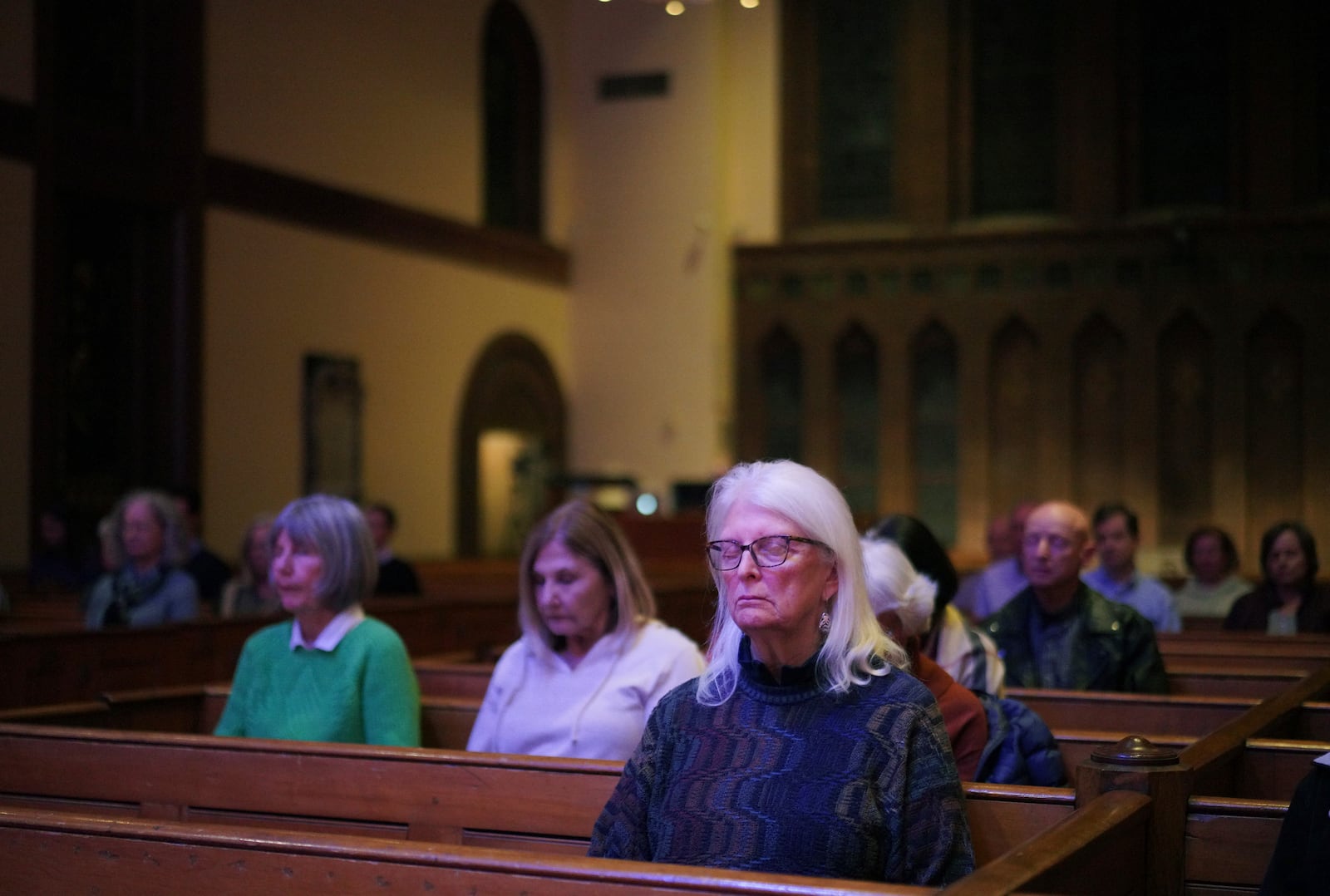 People sit in meditation during a "Contemplative Citizenship" service at St. James Episcopal Church in Lancaster, Pa., on Tuesday, Oct. 15, 2024. (AP Photo/Jessie Wardarski)