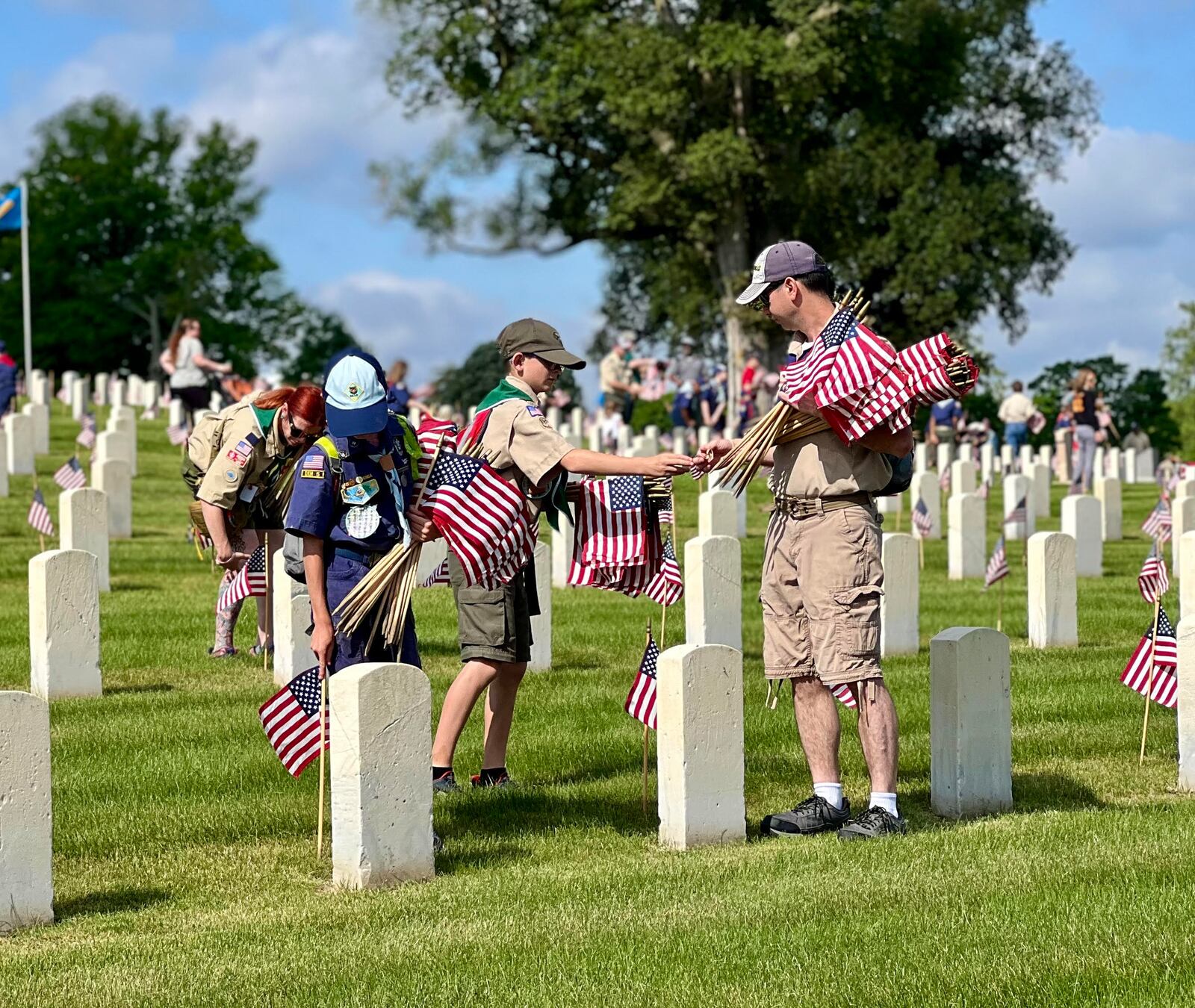 Boy and Girl Scout troops posted American flags at each grave within the Dayton National Cemetery located at the Veterans Medical Center on Saturday. AIMEE HANCOCK/STAFF