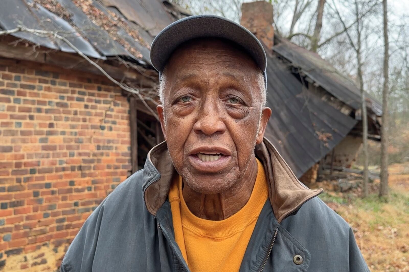 In this image made from an Associated Press video, J.D. Adams talks about his ancestors after viewing their graves at the former Oak Hill plantation outside Danville, Va., Dec. 10, 2024. (AP Photo/Ben Finley)