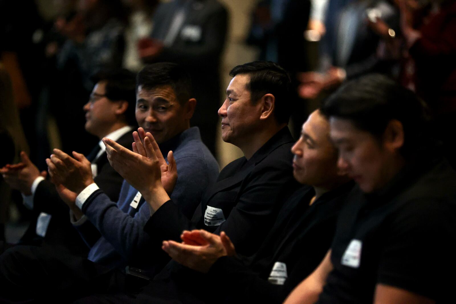 Sharavjamts Tserenjankhar, father of Dayton guard Mike Sharavjamts, watches the speakers at a Mongolian Day event in Dayton at the CareSource building in downtown Dayton on Friday, Feb. 10, 2023. David Jablonski/Staff