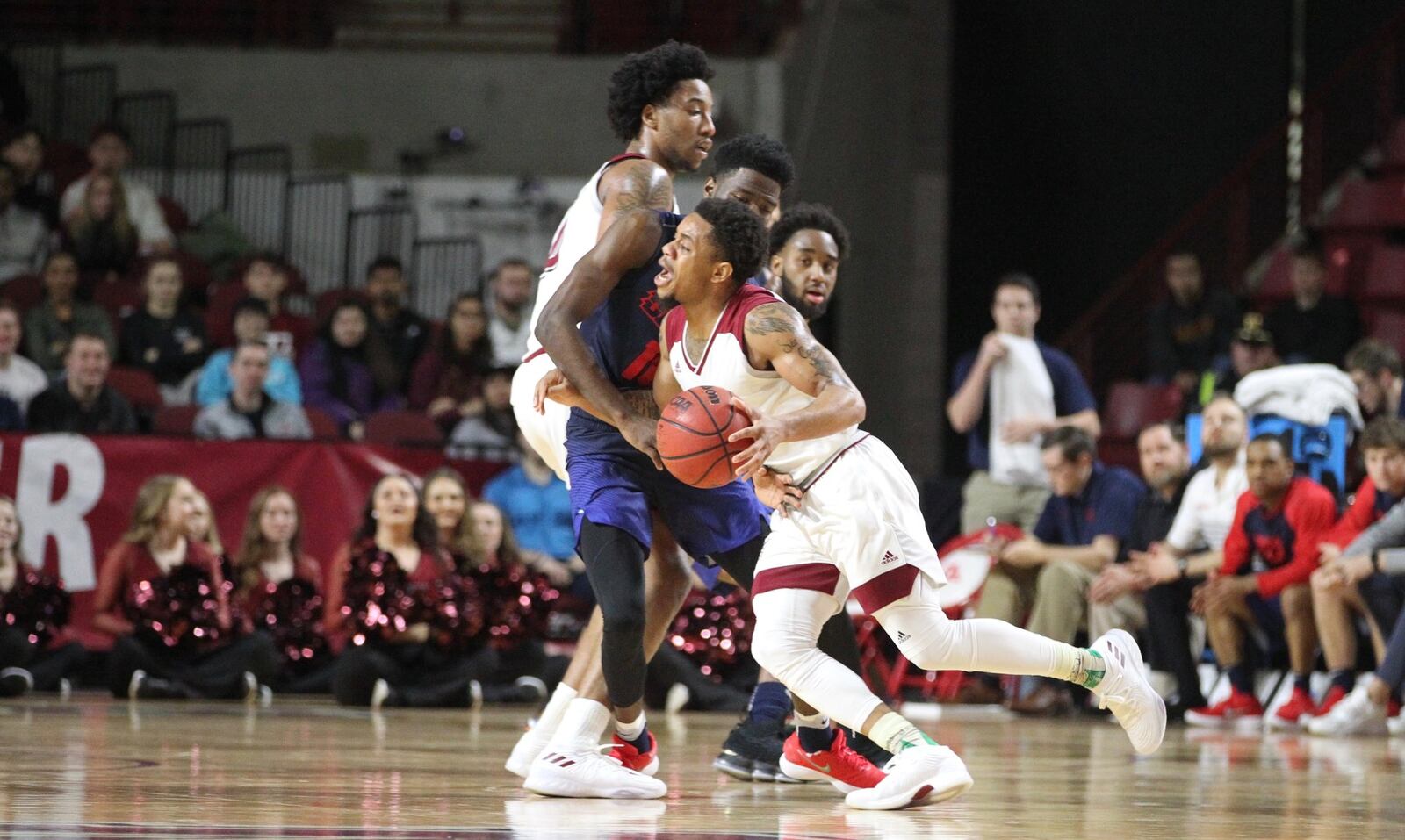 Massachusetts’ Luwane Pipkins runs into Dayton’s Jalen Crutcher on Saturday, Feb. 3, 2018, at the Mullins Center in Amherst, Mass. David Jablonski/Staff