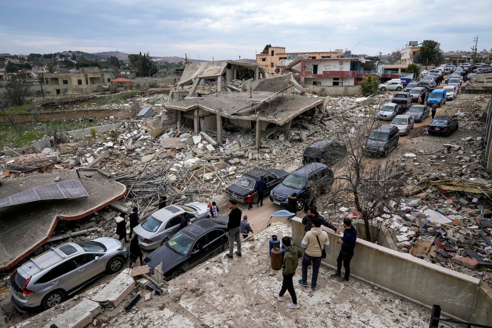 Lebanese citizens return to their destruction homes caused by the Israeli air and ground offensive, in Aita al-Shaab, a Lebanese border village with Israel, south Lebanon, Sunday, Jan. 26, 2025. (AP Photo/Bilal Hussein)