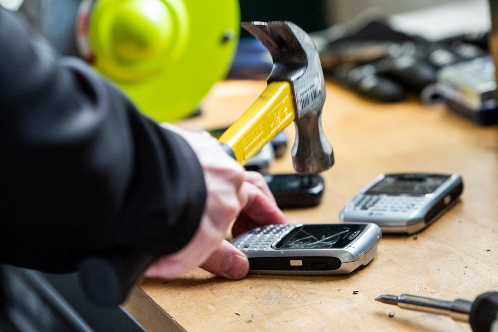 A technician uses a hammer to destroy a cellphone during Classified Cleanout Day at Wright-Patterson Air Force Base on March 11. U.S. AIR FORCE PHOTO/WESLEY FARNSWORTH