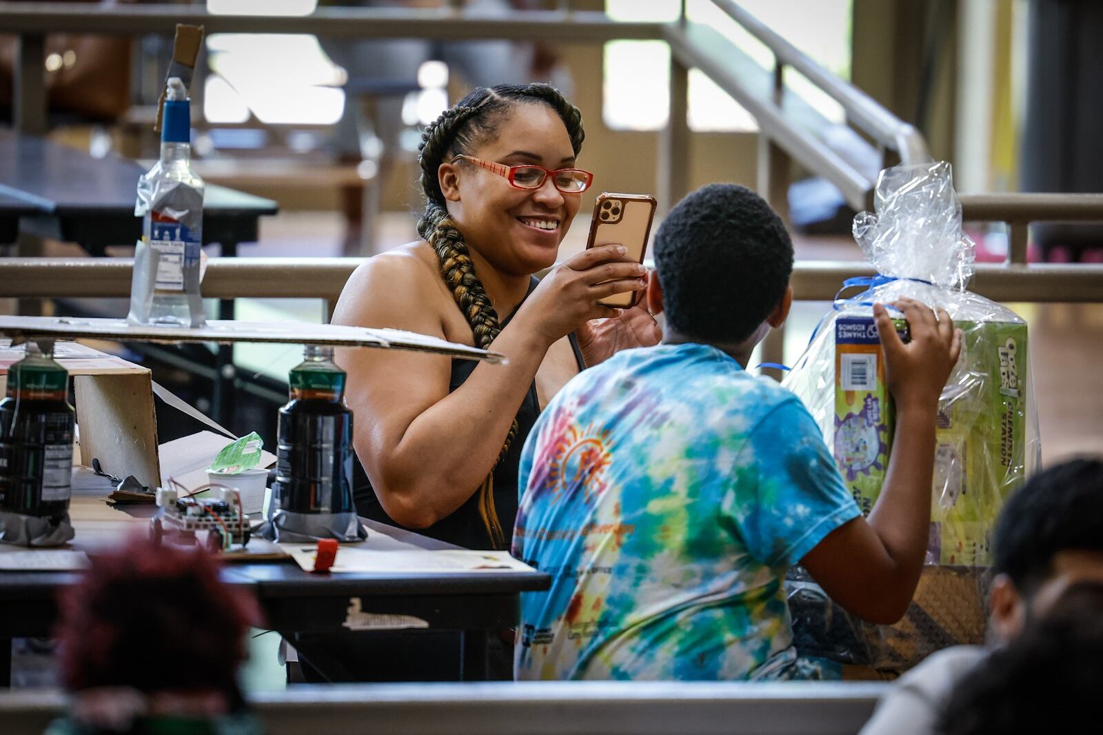 Shaterra Jenkins takes a photo of her son, J'Xavier Jenkins, after he won the leader of the pack award at the STEM Camp held at Weisenborn Junior High School on Friday July 1, 2022. JIM NOELKER/STAFF