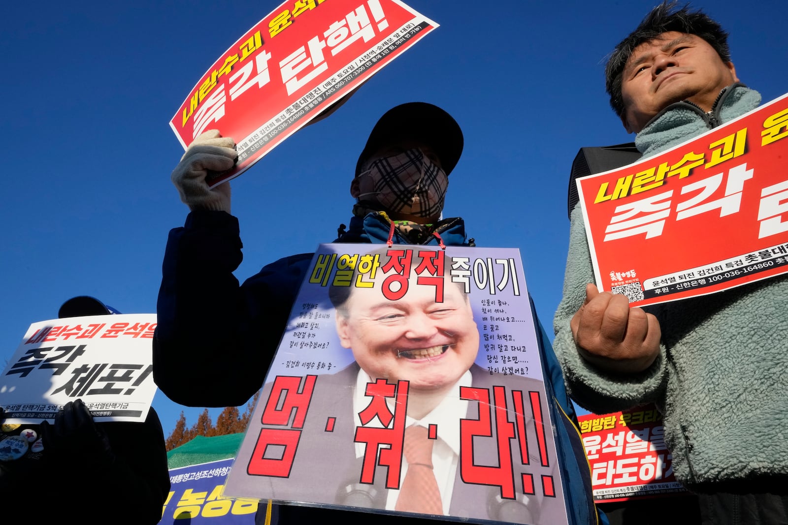 Protesters attend a rally to demand South Korean President Yoon Suk Yeol to step down in front of the National Assembly in Seoul, South Korea, Wednesday, Dec. 4, 2024. The signs read "Stop." (AP Photo/Ahn Young-joon)