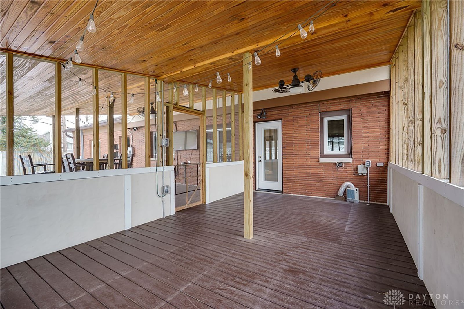 The rear deck has a fully enclosed sun room area and an open area that is covered.