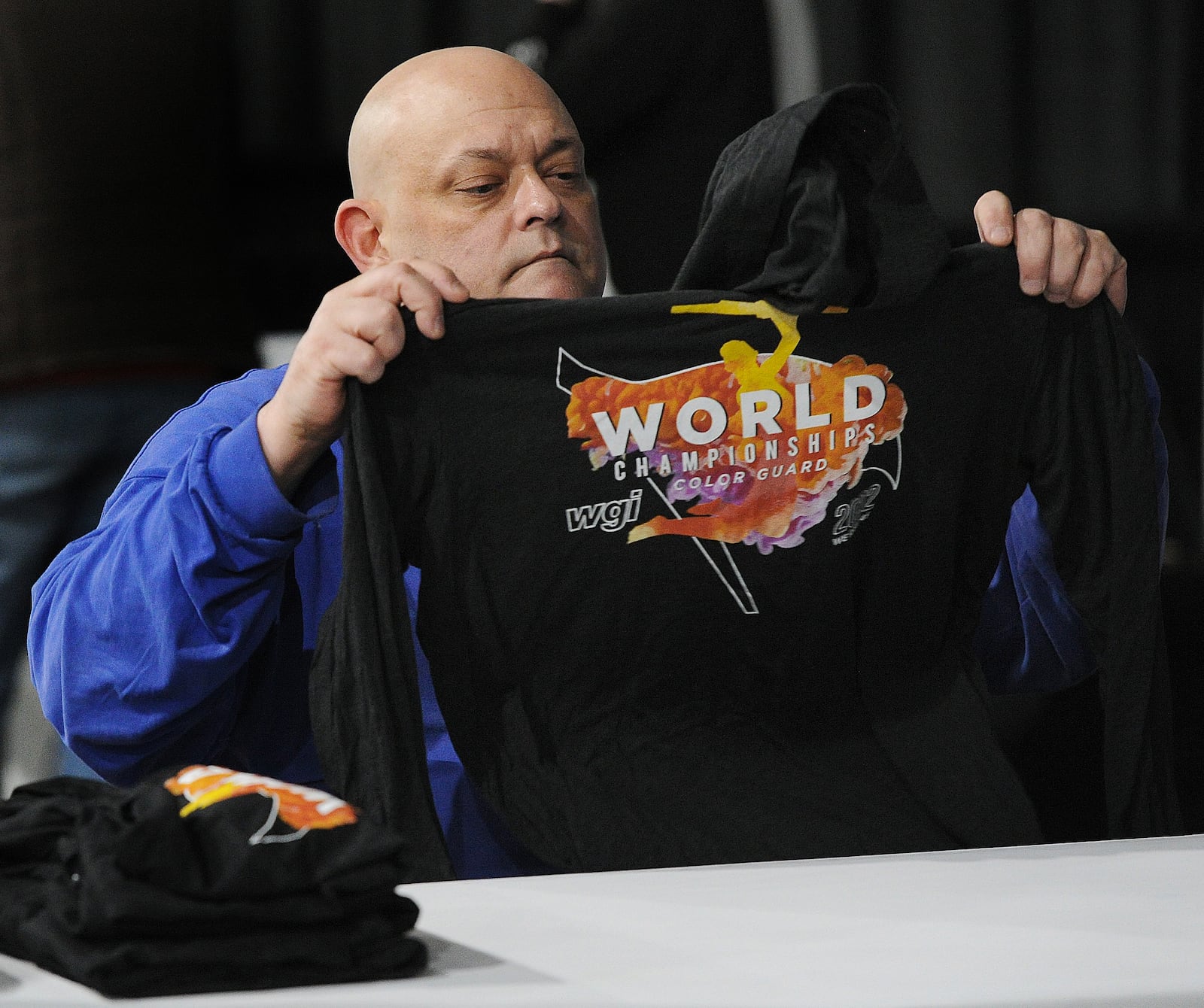 Mike Logsdon, folds shrits Wednesday April 6, 2022 for the winter guard international world championship competition at the University of Dayton Arena. MARSHALL GORBY\STAFF 

