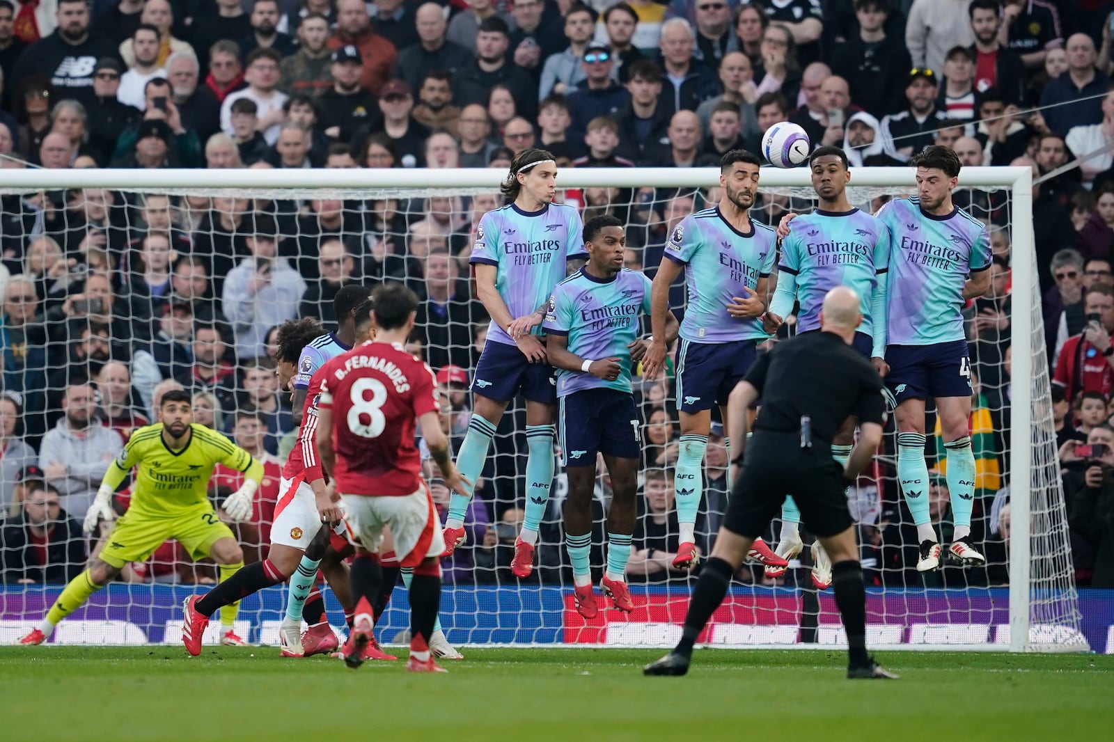 Manchester United's Bruno Fernandes (8) scores his side's opening goal during the English Premier League soccer match between Manchester United and Arsenal at Old Trafford stadium in Manchester, England, Sunday, March 9, 2025. (AP Photo/Dave Thompson)