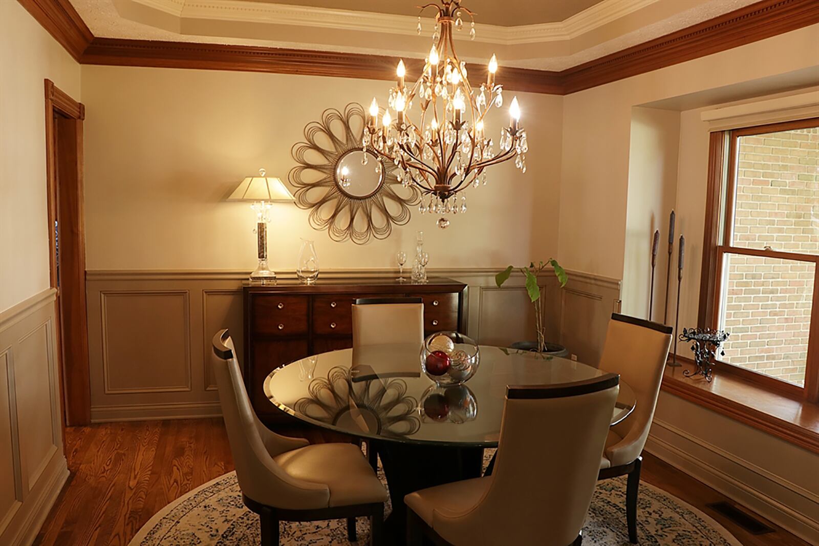 The dining room has wainscoting, a box window with a wood-capped sill and a tray ceiling with dentil crown molding. CONTRIBUTED PHOTO BY KATHY TYLER