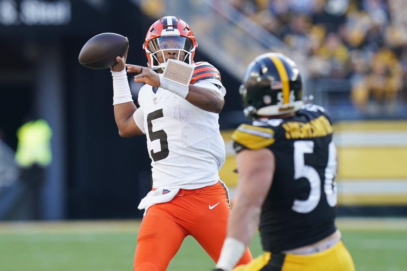 Cleveland Browns quarterback Jameis Winston (5) passes under pressure from Pittsburgh Steelers linebacker Alex Highsmith (56) in the second half of an NFL football game in Pittsburgh, Sunday, Dec. 8, 2024. (AP Photo/Matt Freed)