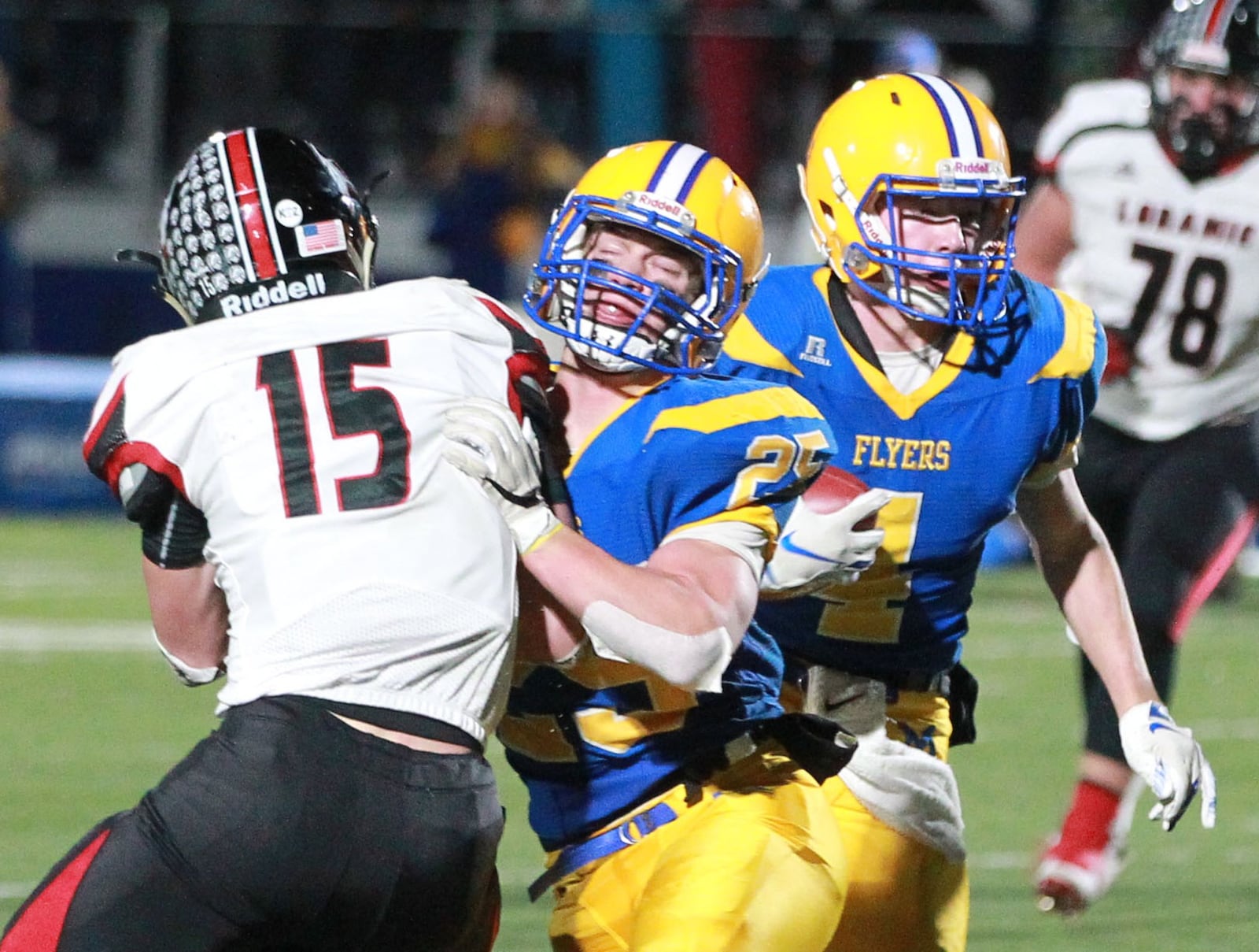 Peyton Otte of Marion Local (with ball) gets a block team Brandon Fleck on Mark Seger (15) of Fort Loramie. Marion Local defeated Fort Loramie 24-21 in OT in a Division VII, Region 28 high school football regional semifinal at St. Marys Memorial on Saturday, Nov. 16, 2019. MARC PENDLETON / STAFF