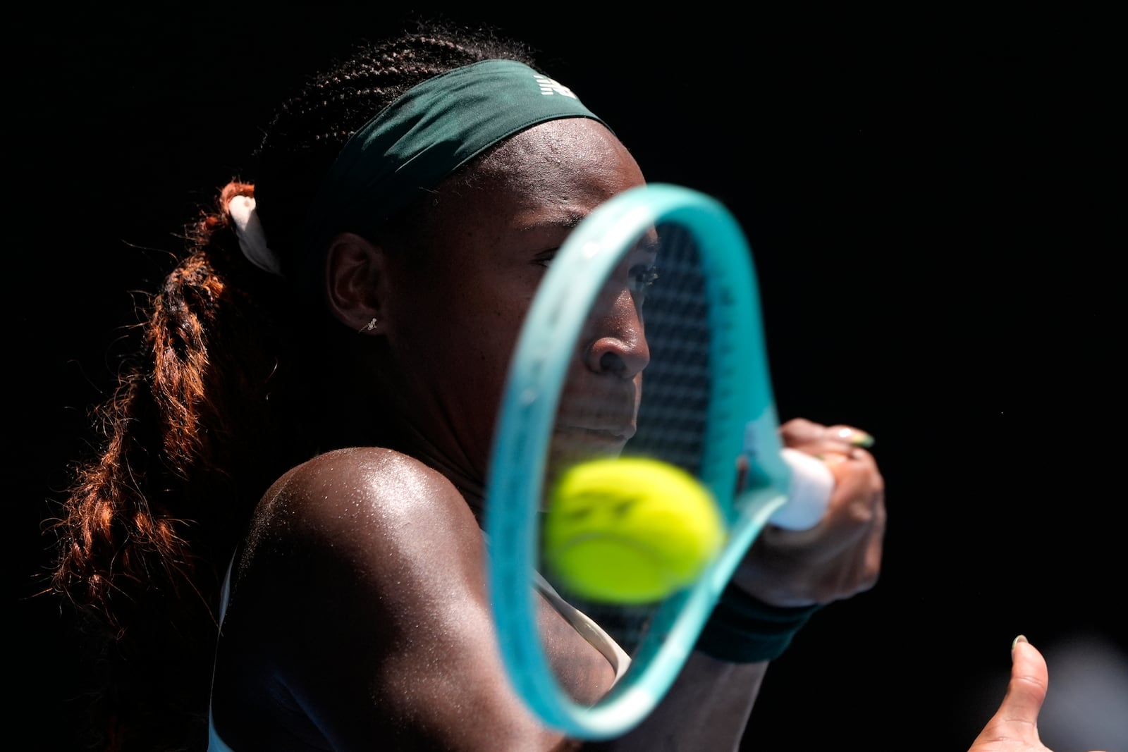 Coco Gauff of the U.S. returns a shot from Belinda Bencic of Switzerland during their fourth round match at the Australian Open tennis championship in Melbourne, Australia, Sunday, Jan. 19, 2025. (AP Photo/Asanka Brendon Ratnayake)