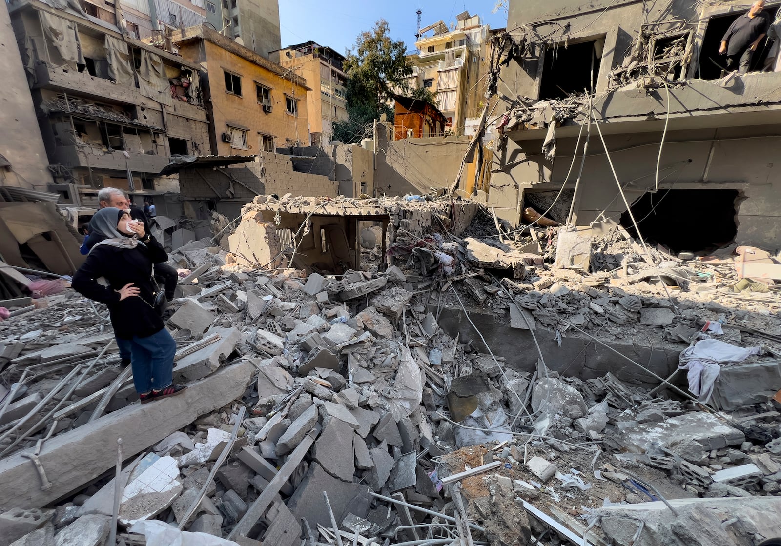 Residents observe the site of an Israeli airstrike that hit central Beirut, Lebanon, Saturday, Nov. 23, 2024. (AP Photo/Hussein Malla)