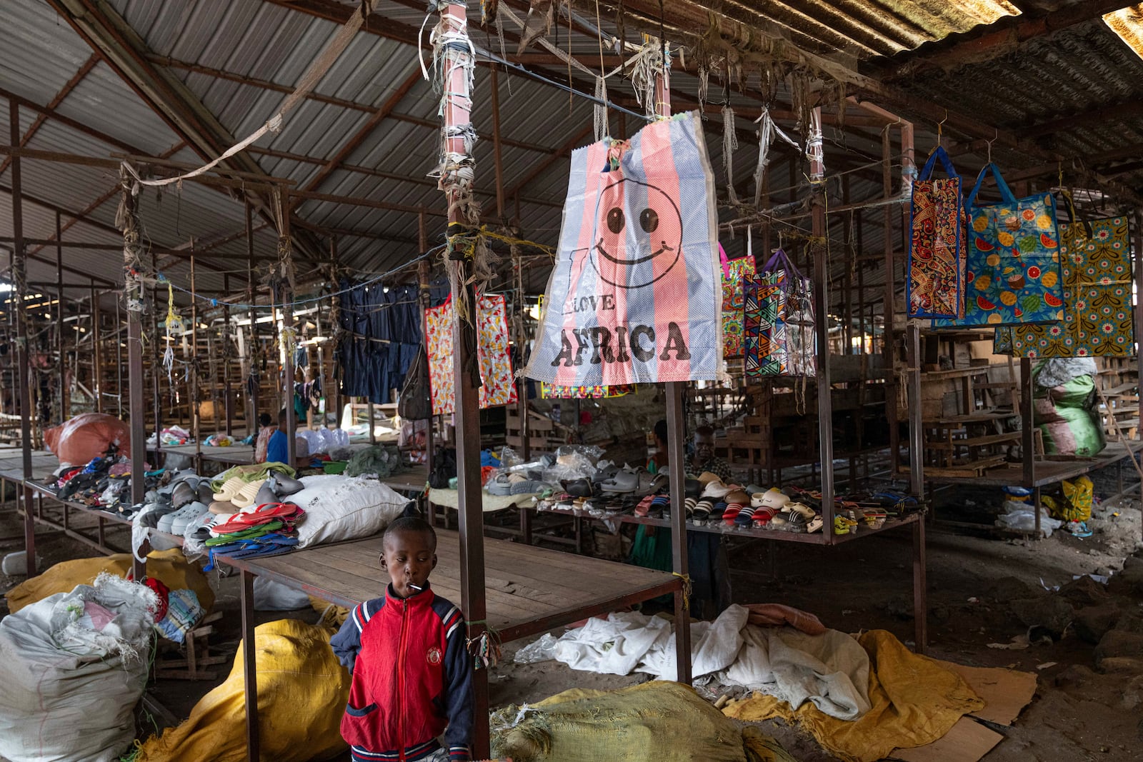 A youth stands in the Virunga market in Goma, Democratic Republic of the Congo, Thursday, Feb. 27, 2025, one month after Rwanda-backed M23 rebels captured the city. (AP Photo/Moses Sawasawa)