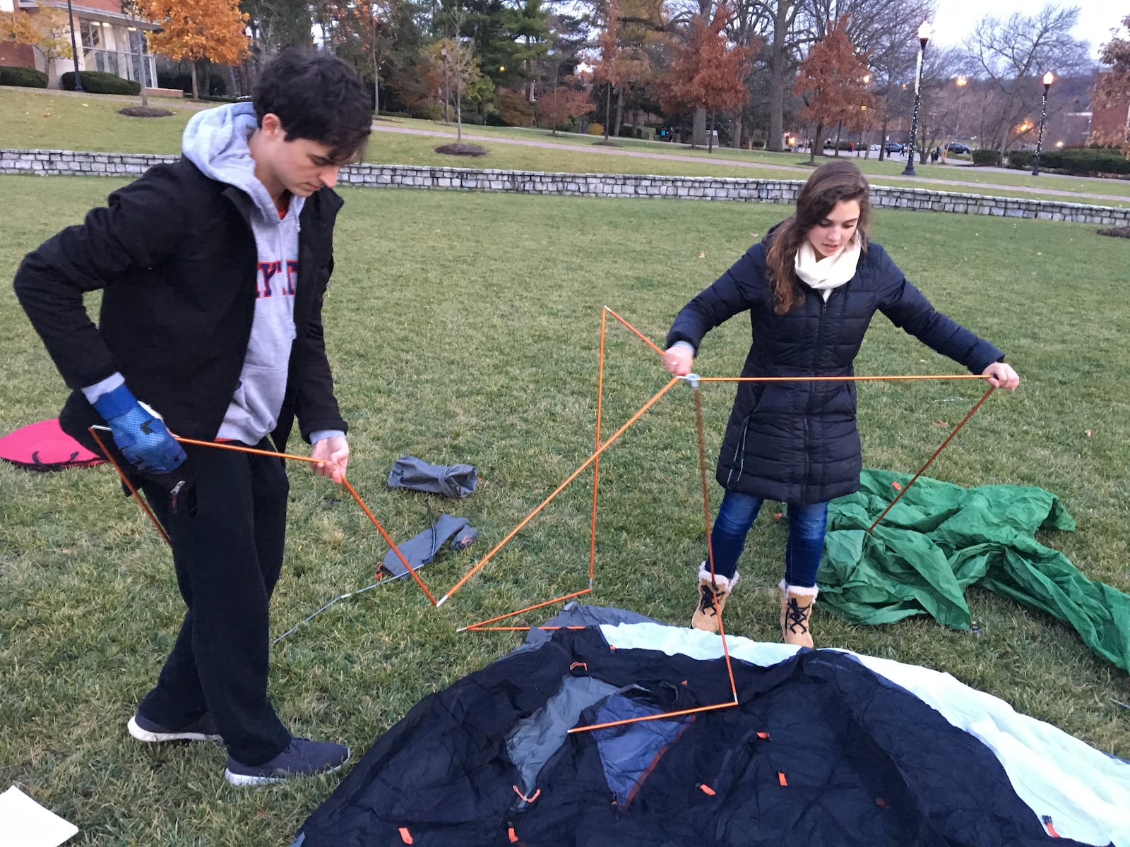 UD juniors Nate Roman and Meg Maloney set up a tent outside Marycrest Hall on campus Monday evening. Students planned to sleep outside in tents to stand in solidarity with people protesting the Dakota Access oil pipeline project at Standing Rock in North Dakota. MAX FILBY/STAFF