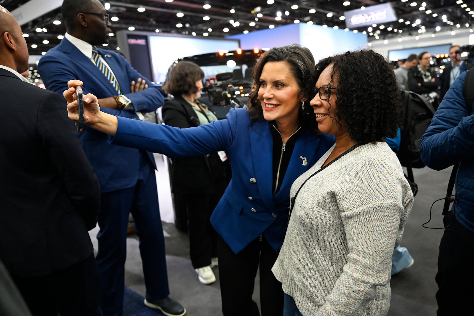 Michigan Gov. Gretchen Whitmer, left, takes a selfie with a supporter at the Detroit Auto Show, Wednesday, Jan. 15, 2025, in Detroit. (AP Photo/Jose Juarez)