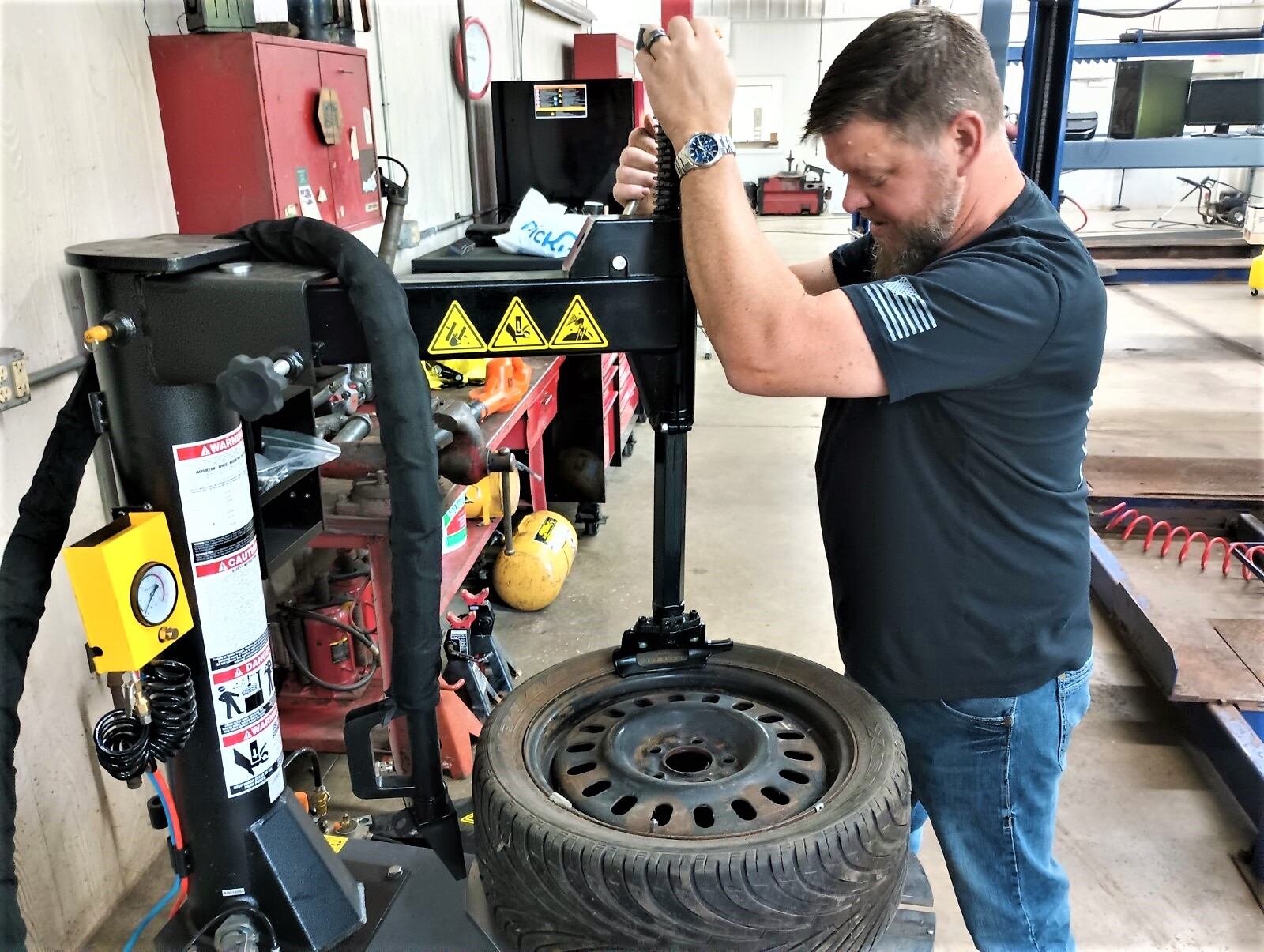 General Manager Micah Steele does automotive work at Pitt Stop Tire and Auto  in Xenia. CONTRIBUTED