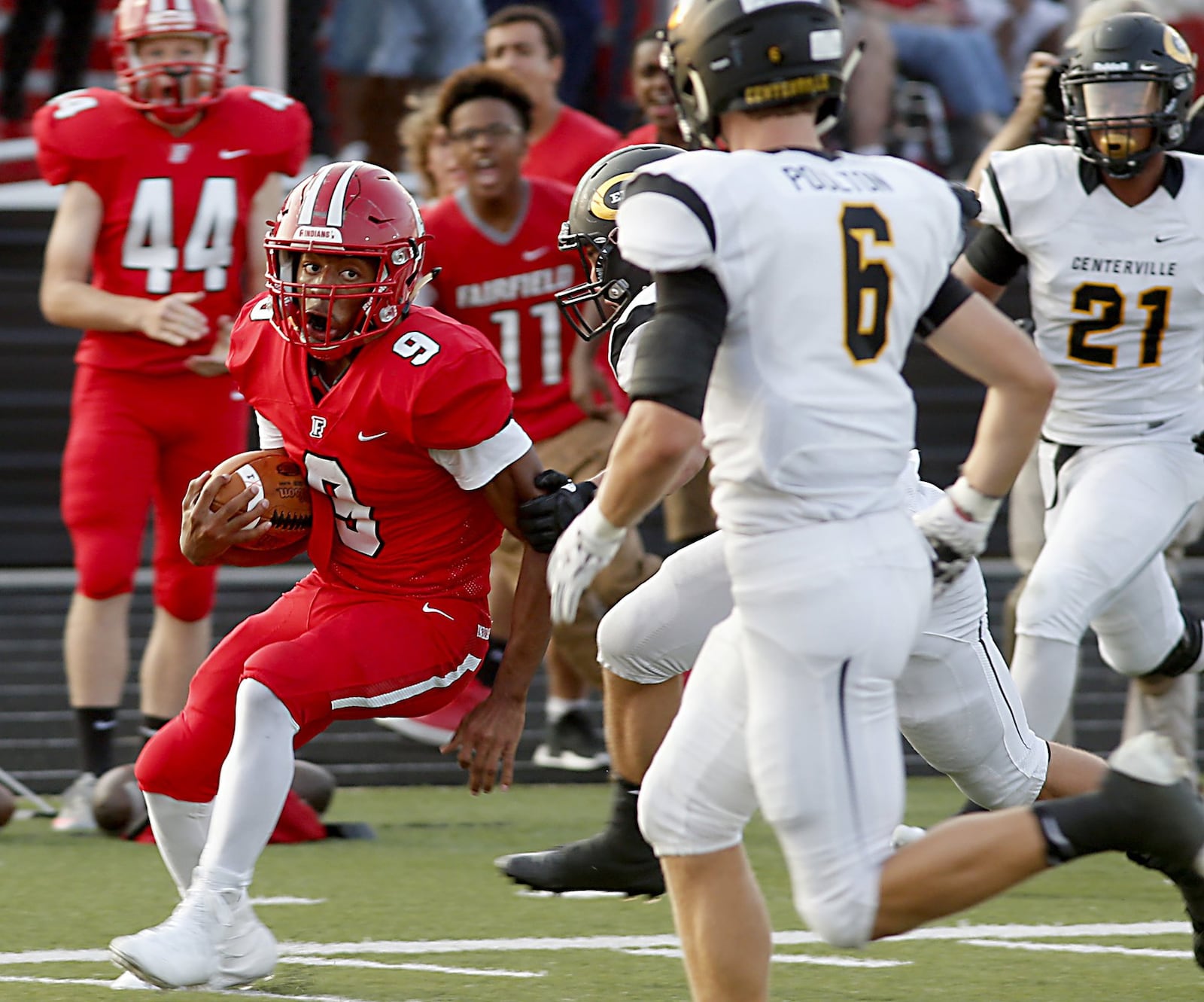 Fairfield running back Jutahn McClain eyes Centerville defensive back Riley Poulton on a touchdown run Friday night at Fairfield Stadium. The TD wasn’t enough in a 30-23 loss for the Indians in the Skyline Chili Crosstown Showdown. CONTRIBUTED PHOTO BY E.L. HUBBARD