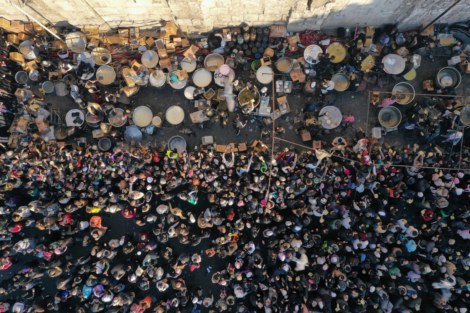 A crowd gathers outside the Umayyad Mosque during the distribution of free meals after Friday prayers in Damascus, Syria, Friday Jan. 10, 2025. (AP Photo/Ghaith Alsayed)