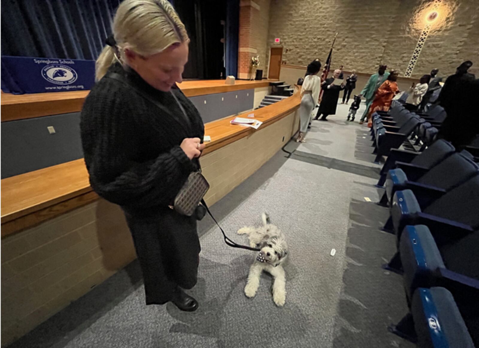 Megan Christiansen, formerly of New Zealand, brought Marvin, her service dog in training to her naturalization ceremony that was held Thursday March 21, 2024 at Springboro High School. Marvin sported a stars and stripes scarf for the occasion. Christiansen is a visual artist who teaches at Wittenberg University. ED RICHTER/STAFF