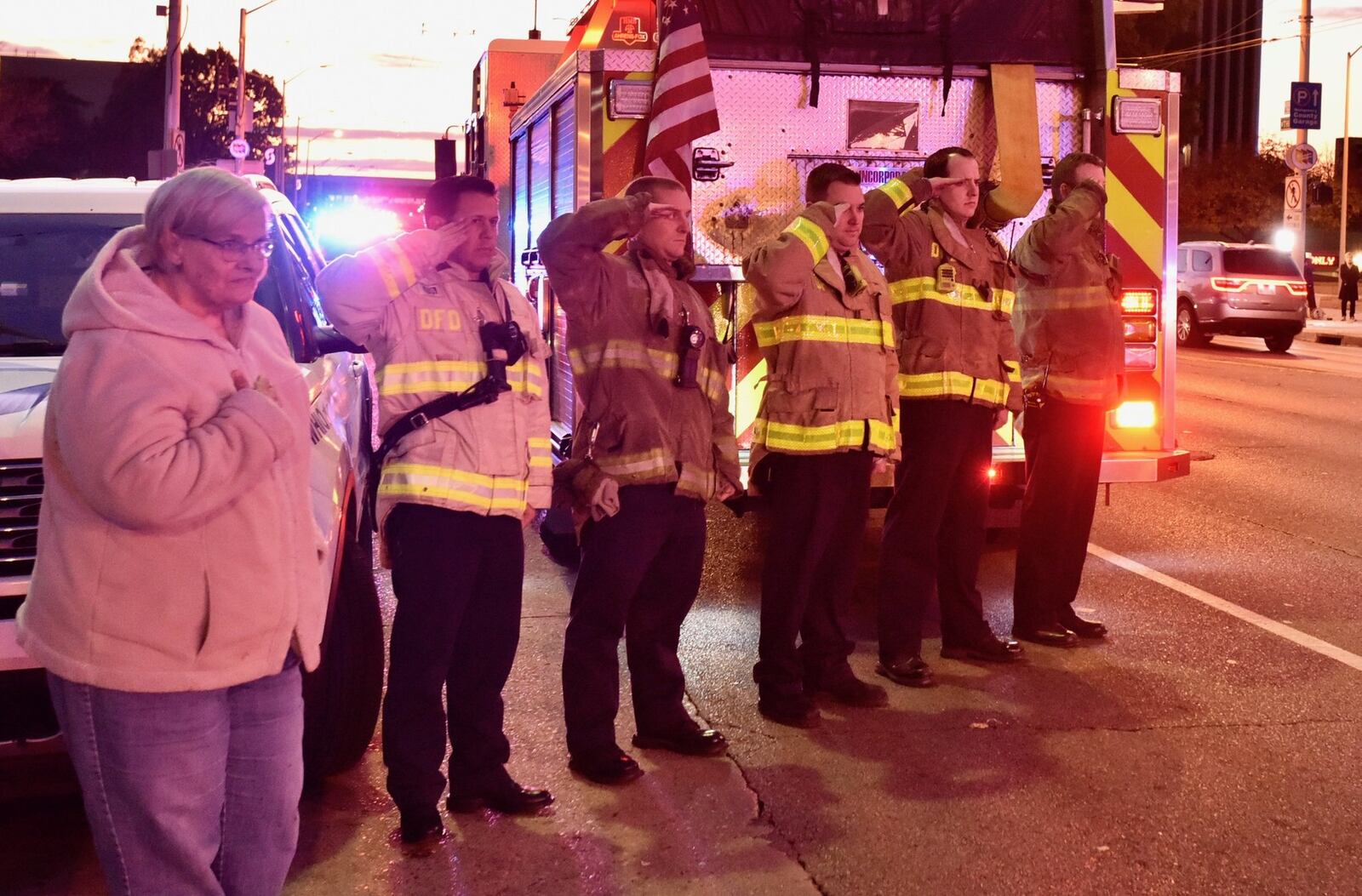 Firefighters and others gather as the body of Dayton police detective Jorge DelRio is taken past the Dayton Safety Center on the way to the Montgomery County Coroner’s Office. NICK GRAHAM / STAFF